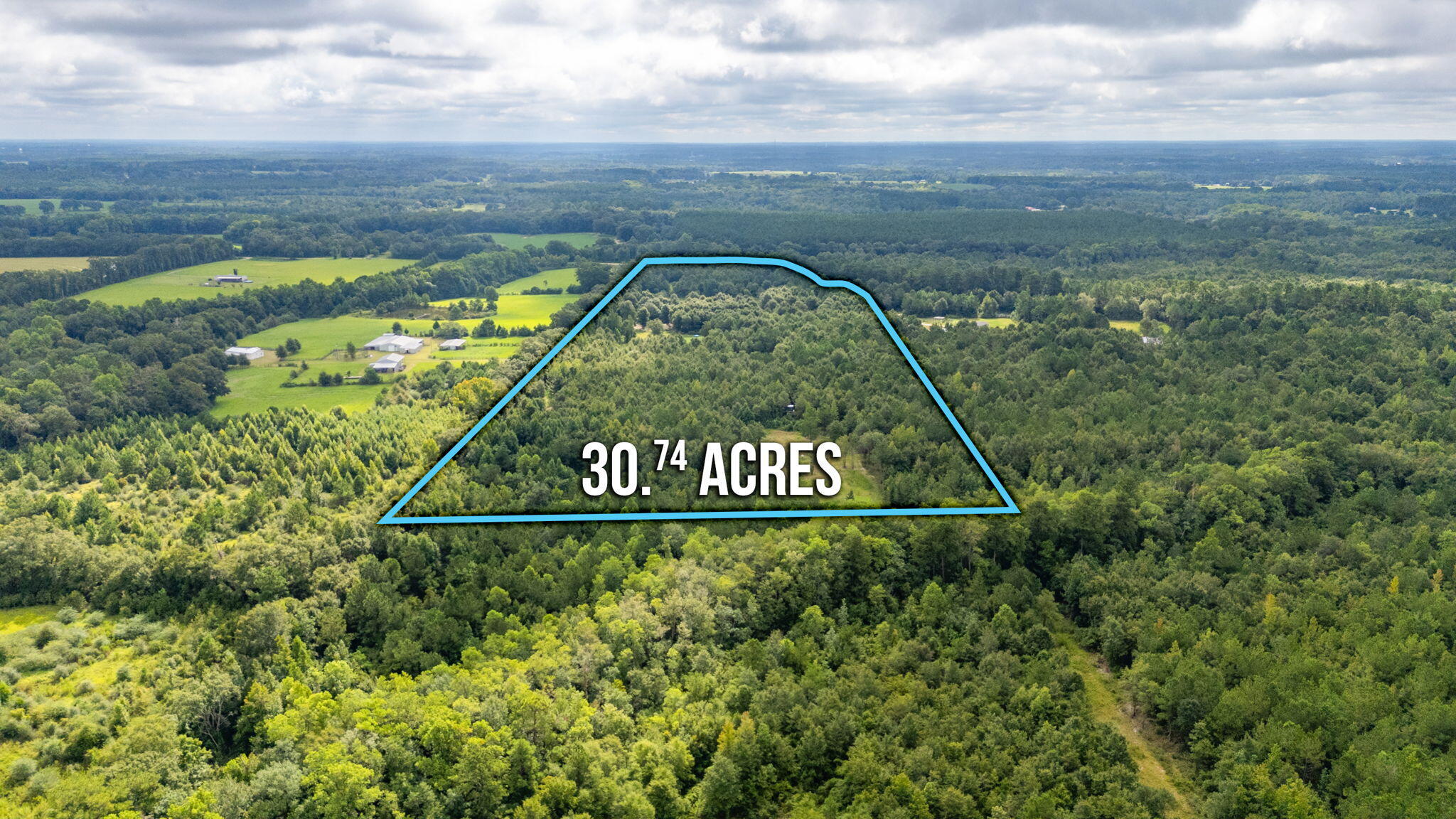 30 acres in North Okaloosa in Laurel Hill offers endless country living. Property comes ready with a well, 2 septic tanks, and fencing ideal for livestock. Property includes a big barn for storage & animals, workshop with a large garage door, a Conex container, & a shed that doubles as a hunting camp. The hunting condo is includes solar power, toilet, and sliding windows. The big carport includes a covered deck designed for camper parking. Relax and enjoy the large screened deck surrounded by fruit trees ideal peaceful evenings. A pond on the property for fishing or livestock watering and tons of wildlife and deer make it ideal for hunting. Looking to raise livestock, hunt, or want to build your dream home, this property delivers. Close to Eglin AFB while having the peace of Country.