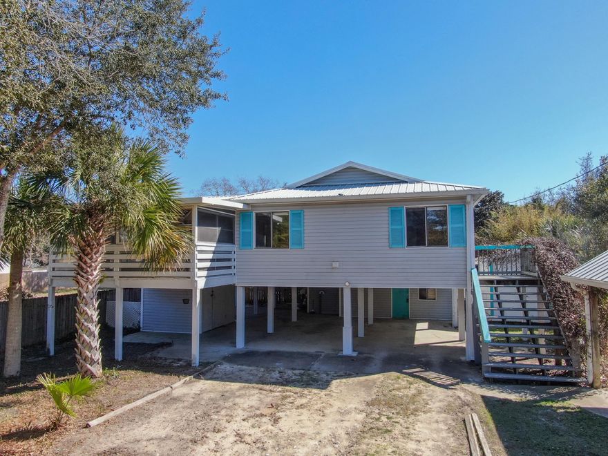 This is the LOWEST PRICED 4 bedroom/3 bath home with inground Pool in all of PCB!! Located on the West end of PCB this beach house is situated on a large 70' x175' lot and has 4 bedrooms, 3 full bathrooms, workshop/storage shed, covered boat space with concrete pad, and an inground pool! 3 of the bedrooms and 2 of the bathrooms are located in the main house plus there's a downstairs lockout studio bedroom with full bath and  private entrance which could be used for MIL suite or for Rental income. This is a great opportunity to own in the Laguna Beach area and could serve as a primary residence, vacation rental or as your second home at the beach! There's No HOA and it's just a short drive to the beach, Pier Park and 30-A. Why vacation here when you could live here year round! Call Today!!