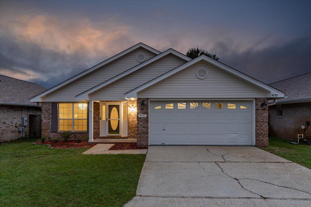 Coastal Cottage Style Brick Home in Parker's Landing - Navarre, Florida.Discover modern comfort and convenience in this updated brick home nestled in the sought-after, gated community of Parker's Landing. This carpet-free contemporary residence offers the perfect blend of style and functionality, just minutes from local bases and beautiful beaches.Recent Upgrades:New roof (December 2021)Fresh kitchen countertops (February 2022)Brand-new kitchen appliances (January 2022)Tankless gas water heater (March 2022)Updated bathroom faucets (August 2024)Impressive Interior Features:Step into an inviting home with a vaulted ceiling living/dining area bathed in natural light. The spacious family room boasts a cathedral ceiling and a charming wood-burning fireplace. Sliding glass doors open to a delightful Florida room, providing bonus living space.
The chef's kitchen shines with gleaming granite countertops, upgraded appliances, and a generous breakfast bar. Convenient inside laundry connects seamlessly to the kitchen and garage.

Comfortable Bedrooms:
The spacious main bedroom features a private en-suite bathroom with:
Double vanities with new faucets
Large shower with built-in seat
Walk-in closet
Bidet-equipped toilet

A split bedroom floor plan offers additional privacy, with two more bedrooms and a full bathroom completing this exceptional home.
Community Amenities
Parker's Landing offers residents:

Community pool
Walking trails
Scenic lake
Secure gated entrance

Energy-efficient and move-in ready, this home combines modern updates with timeless charm. Schedule your showing today and make this your new dream home!