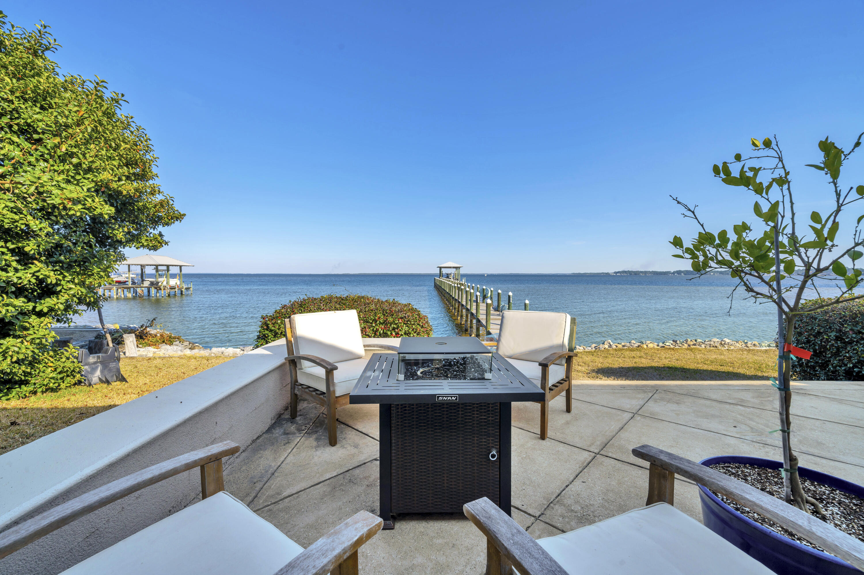 Enjoy some of the best fishing around on your 270-foot dock and watch the dolphins play. New lifts - 12k lb boat lift and 1500lb jet ski lift.Facing due east for endless sunrises. New seawall, roof and hot tub. Private pool located off the primary bedroom. Large 0.67-acre lot in a quiet cul-de-sac, this well-built home has a sweeping circular driveway with ample parking along with a two-car garage. The spacious open floor plan has tile floors and vaulted ceiling. Multiple floor-to-ceiling windows and sliding glass doors capture the amazing views.