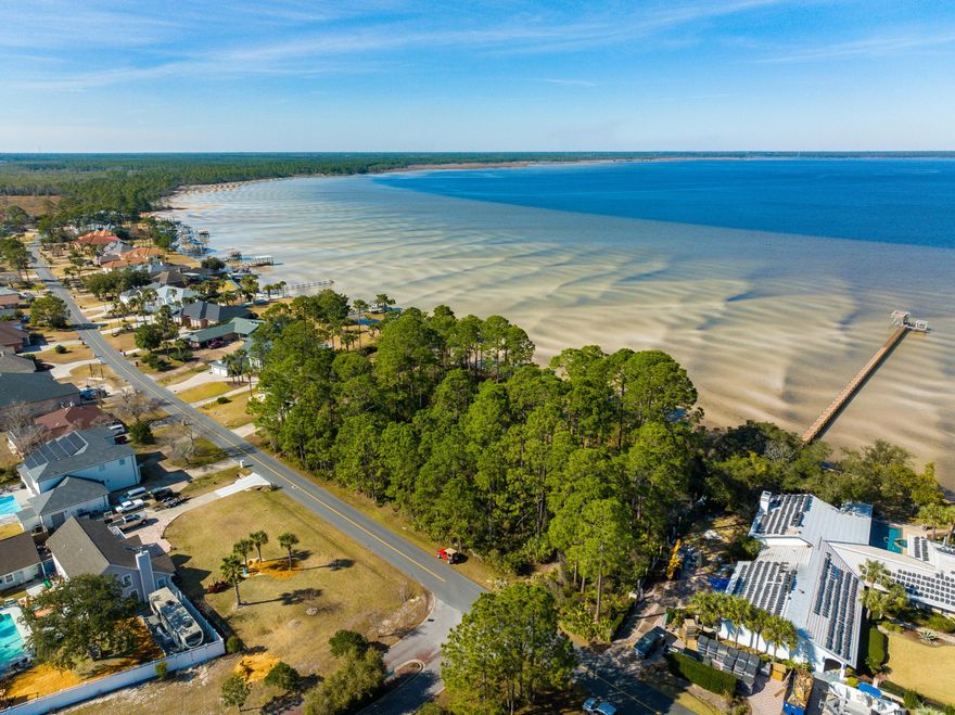 Gorgeous Single LOT with 98 BAY-FRONT FT and GULF ACCESS! Looking for a slice of untouched paradise in one of the fastest growing areas of FL? This VERY RARE gem can be your blank canvas to write your own story. Drive just a few miles away from LUXURIOUS Scenic Highway 30-A & the shops & restaurants of Pier Park to find yourself in what feels like another world. Here, time slows down. You've discovered the slow-moving saltwater marsh known as West Bay, one of the most beautiful secrets of the Emerald Coast. 25 minutes by boat to the turquoise waters of the beach, you truly can experience the BEST of both worlds! This fortified parcel is protected by a Sea Wall to prevent erosion.