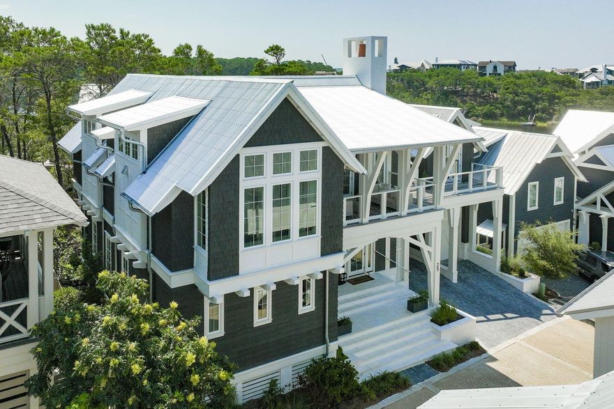 This newly-built stunner in the gated and private Draper Lake Coastal Village wont last long! 25 Bluff Lane is sold fully furnished and offers rare Gulf and coastal dune lake views. The home features an expansive 3,174 square feet of living space that boasts five beds, five full baths and two half baths. The floor plan offers multiple living spaces and a semi-detached carriage house wrapped in multiple cantilevered porches. Exquisite finishes have been carefully curated to deliver a thoughtful design experience. An outdoor living terrace with a summer living terrace with a summer kitchen that anchors an entertaining space that is both functional for entertaining and smartly conceived for relaxation. A combined garage and carport provide room for four vehicles, multiple bicycles and...