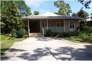 Highly sought-after rental capable Prestwick Place single story cottage in Sandestin Resort. Large lakefront lot with mature landscaping that offers a private retreat. Three bedrooms and 2 1/2 baths, wrap around front porch, screened-in porch in back, wood floors, lots of windows and much more. Separate garage has been added. Being sold furnished (except for a few items that belong to current renters).