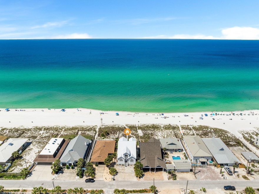 Beachfront Paradise AwaitsExperience the ultimate in beachfront living with this stunning 6-bedroom, 4-bathroom fully furnished home, perfectly situated on the Gulf of Mexico in East Panama City Beach. Just a short walk to local restaurants, shopping and entertainment, this property offers breathtaking views and the convenience of a prime location.Step onto the expansive beachfront deck, built with durable Trex decking and equipped with a staircase that leads directly to the sand. After a day by the water, rinse off in the outdoor shower and unwind as the sun sets over the Gulf.Inside, the main level features an open-concept living and dining area with tall ceilings and luxury vinyl plank flooring, perfect for entertaining.