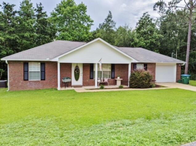 Prepare to fall in love with this adorable 3 bedroom, 2 bath home on .44 of an acre, South of I-10! All diagonally tiled floors, except in bedrooms, keeps maintenance low and easy. Living room has a vaulted ceiling. Kitchen features smooth top stove, built in, stainless steel microwave, and extends into the spacious dining area. The Master bedroom features a trey ceiling and wonderful walk in closet. This split bedroom floor plan offers 2 additional bedrooms, with a full bath in between. Step out onto the extended, newly stained and sealed deck, overlooking tons of privacy. You'll enjoy watching nature in all its bounty with birds of every kind, while you dine outside, if you wish. Oversized garage has attic storage. A sprinkler system & shed completes this home. All brick and ready to go!