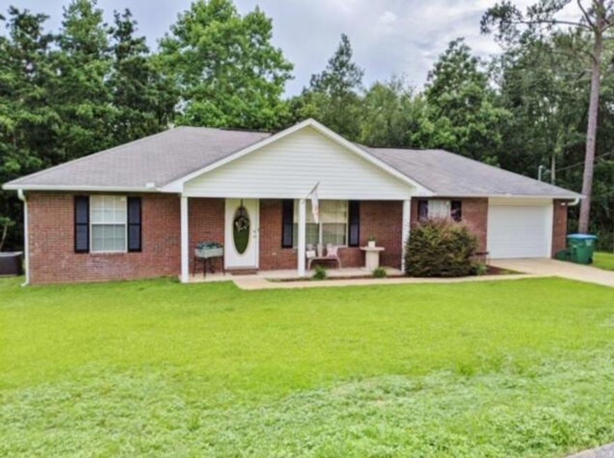 Prepare to fall in love with this adorable 3 bedroom, 2 bath home on .44 of an acre, South of I-10! All diagonally tiled floors, except in bedrooms, keeps maintenance low and easy. Living room has a vaulted ceiling. Kitchen features smooth top stove, built in, stainless steel microwave, and extends into the spacious dining area. The Master bedroom features a trey ceiling and wonderful walk in closet. This split bedroom floor plan offers 2 additional bedrooms, with a full bath in between. Step out onto the extended, newly stained and sealed deck, overlooking tons of privacy. You'll enjoy watching nature in all its bounty with birds of every kind, while you dine outside, if you wish. Oversized garage has attic storage. A sprinkler system & shed completes this home. All brick and ready to go!