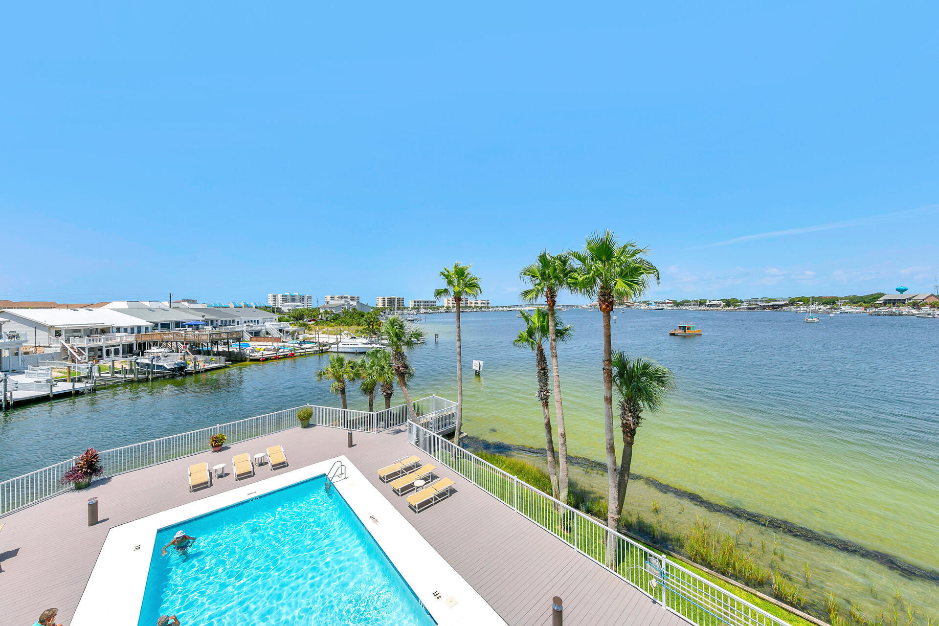 Located in the exclusive gated Destin Harbor Resort, this condo offers a serene atmosphere with a strict ban on short-term rentals, ensuring peace and tranquility for its residents. You will enjoy a variety of amenities including private beach access, pool, a picnic Pavillion, BBQ grills, separate storage room, and access to your very own boat slip making it an ideal place for both relaxation and recreation. This condo is part of the highly sought after C Stack. These units are rare on the market, highlighting the unique opportunity to own a piece of this prestigious property. The condo features two large balconies that offer sweeping views of the harbor and the Destin Bridge. These breathtaking vistas can be enjoyed from the living area, dining area, as well as both bedrooms, providing a constant connection to the beautiful surroundings.The main living and dining areas are generously sized and feature elegant tile flooring, creating a spacious and inviting environment. The kitchen is equipped with granite countertops and beautiful soft close cabinets and drawers, combining functionality with aesthetic appeal. This gated community consists of only 24 units, ensuring a secure and close-knit environment. Residents can enjoy spectacular fireworks displays, vibrant boat parades, stunning sunsets, and frequent dolphin sightings right from your very own  balcony. This condo at Destin Harbor Resort represents a rare opportunity to enjoy luxurious living in a serene and exclusive setting, with unmatched views and premium amenities. 