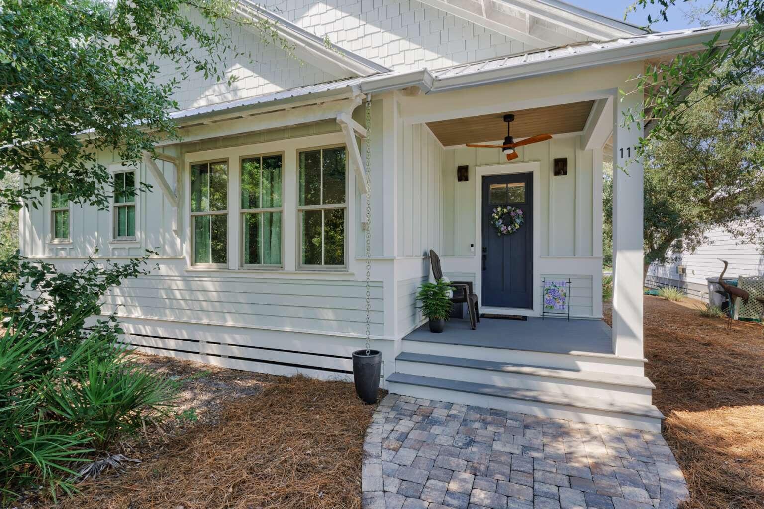 Located in the Point Washington Road community with access to all the outdoor activities that South Walton has to offer, 117 Devlieg Avenue is ideal as either a primary home or vacation home! The spacious single-story floorplan with 10-foot ceilings features 4 bedrooms, an office, separate living and kitchen spaces, and a central exterior porch, as well as a full 3-car garage. As you enter the home, step into a dedicated foyer area that opens up to both the office space with front-yard view and the large main living space with 12-foot ceilings and custom trim accents. A secondary bedroom with en-suite bath is located to the front of the home. Two additional guest bedrooms with a shared bathroom are located centrally. The separate kitchen features ample storage and counter space, and GE Profile appliances meaning that there is always room for cooking a fine meal. The private master bedroom at the rear of the layout features a wood-plank tray ceiling, and a gorgeous private bathroom with walk-in closet. The central porch can be accessed from the dining space. There is parking space for 3 full-size vehicles in the detached garage, and three more can fit in the driveway. For boaters and kayakers access to the Choctawhatchee Bay is located just one block away via a hidden-gem public boat-launch into McQuage Bayou. If you prefer walking or riding to the Bay, the nearest public access is less than a half-mile down the street. And for hikers, Point Washington State Forest runs the length of Point Washington Road, just a block South. With a central porch, a stand of old-growth in the front yard, and HOA-maintained greenspace directly across the street, the home provides nature and seclusion--even in the midst of a vibrant neighborhood with conveniently-located community pool and nearby to dining and shops. With a mix of private comfort inside and immediate access to a variety of natural wonders outside, this beautiful custom home is uniquely situated to provide everything you are looking for.