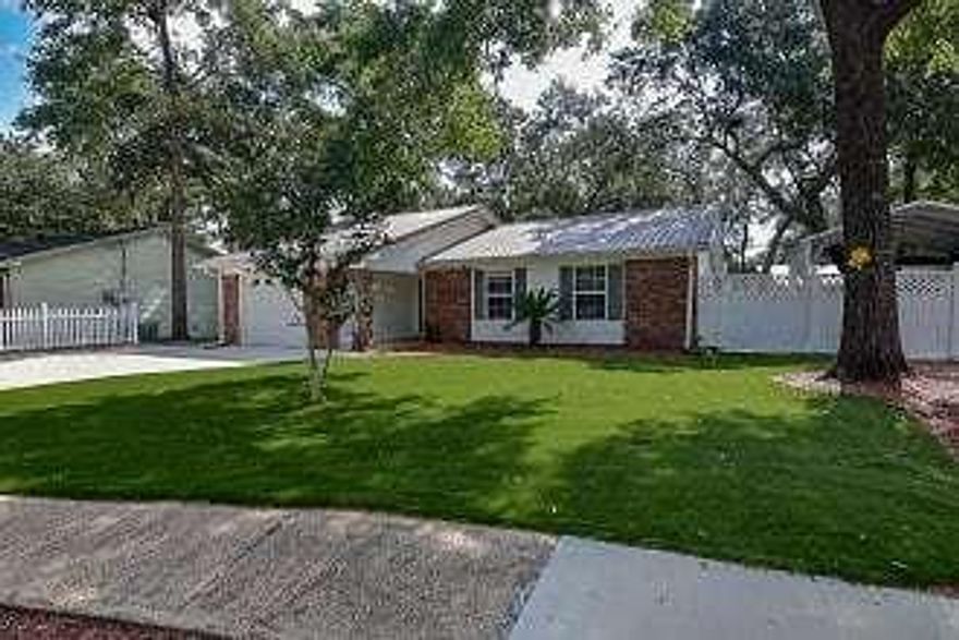 Meticulously maintained, lovely home close to all that Niceville offers! Open, airy and renovated, this home is low maintenance with no mowing required! Metal roof and new wood laminate flooring throughout as well as new 2017 kitchen appliances. Unique, very low maintenance turf landscaping with a fountain and room for games and entertaining and pets in the fully fenced backyard. Shed and covered boat/RV storage with electriciy behind the double gated fence. Garage is currently a bonus room with air conditioning, but could easily be converted back to store one car and provide additional storage. Located on a quiet cul-de-sac, this 3 bedroom, 2 bath home is perfect for a growing family or empty nesters with some ''toys'' for outdoor or travel adventures! Very cute and won't last long!