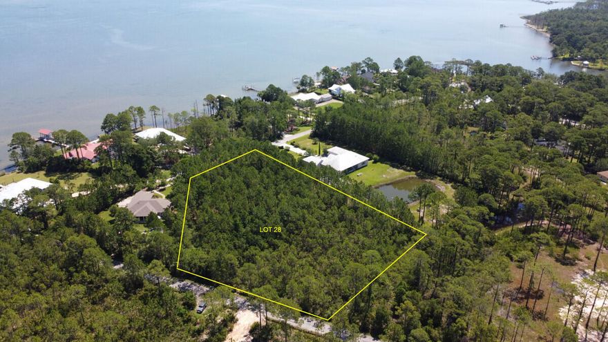 ONE OF A KIND RARE OPPORTUNITY!!  Will not last at this price.  This is a rare opportunity to purchase one of the largest lots in the coveted Woodland Bayou Estates neighborhood.  This huge 2.3 acre lot has stunning Bay Views!  The lot is high and dry with only a very tiny area (0.07 acre) of wetlands at the rear corner near Don Bishop Rd.  Woodland Bayou Estates is an exclusive bay-front neighborhood with all Estate sized lots, and exquisite homes!  This two and a half acre lot is at the end of the cul de sac on Woodland Bayou Drive, but also has 160 feet along Don Bishop rd on the rear of the lot, allowing access to launch kayaks, paddle boards, and jet skis at Don Bishop end!  If you are looking to build your forever home this is the perfect location. Recent survey and studies available