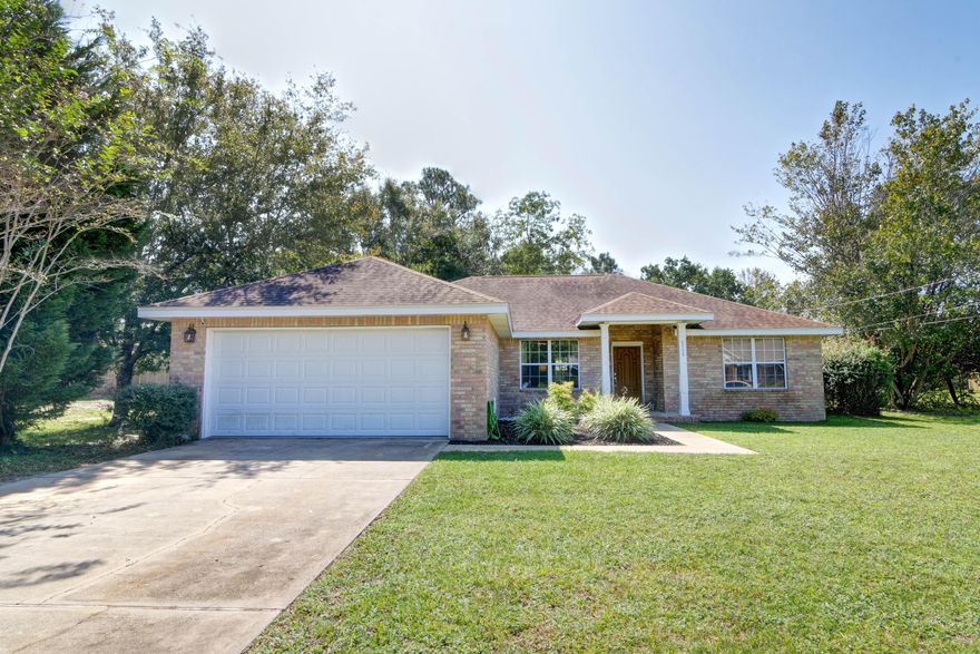 Beautifully updated in Holley by the Sea! Located on a half acre lot this all brick beauty has undergone a transformation and been well maintained by its owners with a long list of seller upgrades! Appreciate the large lot and curb appeal as you pull in the driveway, and upon entering the front door you'll love the open floor plan! The formal dining room is currently used as a play room/reading nook, and you'll find the newly installed wide plank laminate flooring throughout (absolutely no carpet!) and updates like new lighting, freshly painted walls, new fixtures, sinks, and even a new bathroom vanity (check out the updates for a complete list). The living room features a wood burning fireplace, and it's open to an additional eat in space in the kitchen. The kitchen is complete with stainless appliances, a new sink, faucet, and range hood as well as a separate pantry. The split floor plan allows for owner's bedroom privacy, and the bathroom has walk in closet, double vanities, and separate soaking tub and stand up shower. The other two bedrooms (one with an adorable shiplap wall!) are ample sized with a shared full bath between them. Outside is a great sized backyard to enjoy, and have peace of mind with an alarm system, transferrable termite bond, septic system replaced in 2018, fabric shield hurricane shutters, a water heater replaced in 2013, and roof in 2005 with dimensional shingles. Welcome home!