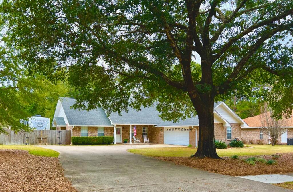 Charming home in desirable Rocky Bayou Estates on almost a half acre lot. This split bedroom floorplan features many upgrades throughout. The Great room boast a Cathedral ceiling, tile flooring, updated built in cabinetry and a gas fireplace with French doors leading to the screened porch. The remodeled kitchen features updated cabinets, granite counter tops and a breakfast bar that overlooks a family room. Master bedroom features a sitting area and tray ceiling. Master bath is complimented with a separate tiled shower, garden tub, double vanities and a large walk-in closet. Two bedrooms on the left of the great room share a jack and jill bathroom and offer plenty of closet space. There is a Screened porch & an open patio great for entertaining. Plenty of room for a pool if desired. The laundry is good size and offers more cabinets, and a counter top handy for folding your laundry and a utility sink. There is a Boat/RV pad in the back yard with a 50 amp service. There is also electric to the yard building with 100 amp service. On the right side of the home there is a slab for a generator. All information deemed to be correct, buyers to verify.