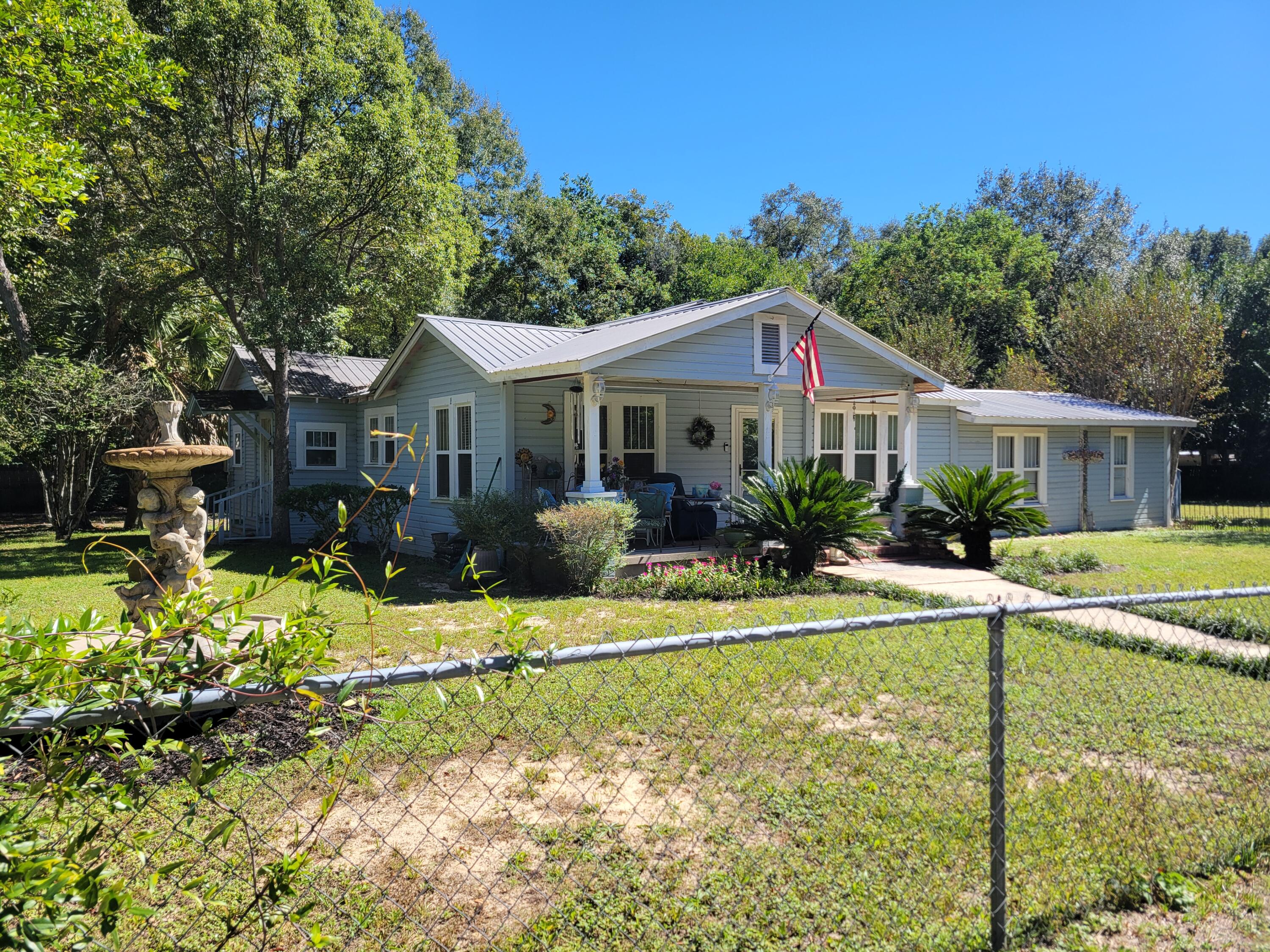 Just 4 blocks South of Lake DeFuniak!  This darling FL Cottage style home has part original hardwood floors and updated flooring is waiting for you.  New plumbing throughout and electrical has previously been updated.  Home has 2 bedrooms and 2 bathrooms at the present time, but more living area to make a 3rd bedroom or mother-in-law suite.  This is a CASH SALE since needing the final touches.  Downtown Historical DeFuniak, Reflections Christmas Light Show and many other social activities are within walking distance.  It is in route to the South Walton beaches and more shopping and restaurants along the way.  Partial chain link fencing.  So, if  you are a Buyer looking for a sweetheart of a home to put the finishing touches on, then this is the home for you.