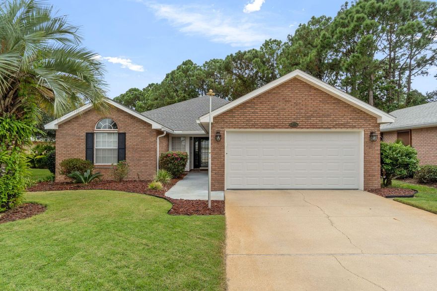 Positioned within the peaceful enclave of Treetops at Bayside, this beautifully updated three-bedroom, two-bath residence sits on one of the neighborhood's larger lots, offering nearly a quarter acre of landscaped serenity. The single-level layout features matching hardwood floors, abundant natural light, and an inviting living area anchored by a gas fireplace with a cozy reading nook nearby. The kitchen has been tastefully refreshed with stainless steel appliances, new quartz countertops, and recessed lighting. Peace of mind ensues with all major mechanicals up-to-date including the roof(2021), HVAC(2024), and brand new water heater (10/2025). Step through the french doors onto more than 200 square feet of screened outdoor living space overlooking a fenced backyard bordered by mature trees and lush foliage for exceptional privacy. Thoughtful details include hurricane shutters, a transferrable termite bond, and a two-car garage with built-in cabinetry and counter space. Residents of Bayside enjoy access to a bay-front dock, community pool, tennis courts, park, and pavilion, while nearby Legion Park offers a public boat launch, pickleball courts, and playground. This move-in-ready home captures the comfort and convenience of coastal living with space to relax both indoors and out. Don't miss out on this meticulously maintained home in a remarkable location.