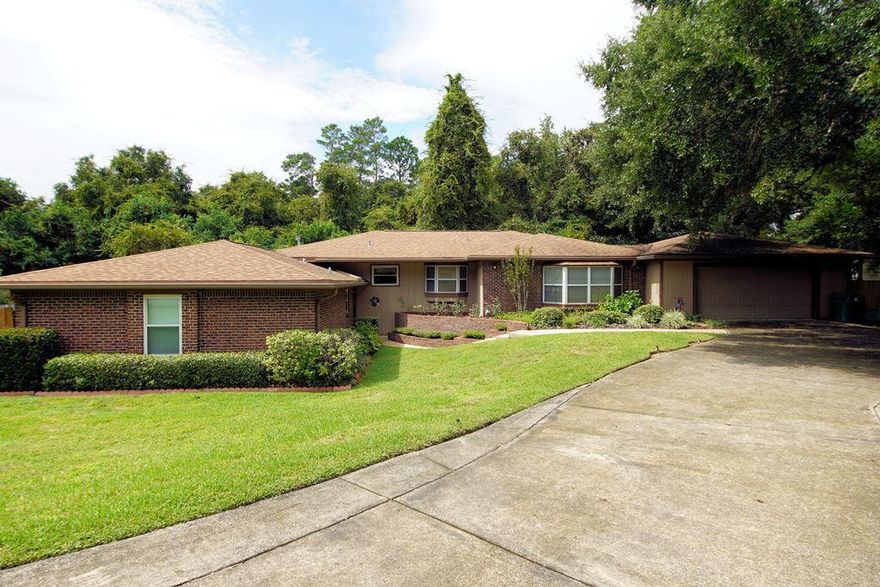 ROOM TO ROAM in this sprawling split-level ranch house with multiple living areas located on a large, private fenced lot in the heart of Niceville! The home is situated on a .36 acre lot at the end of a quiet cul-de-sac street with lots of privacy in the large back yard that borders a city owned greenbelt. When you enter this home you will find yourself in a large foyer that opens up to a wonderful family room accented by a cathedral ceiling and soaring windows that let in lots of natural light. There are 5 wide steps up to the renovated kitchen and dining area. The large kitchen was updated in 2001 to include plenty of warm oak cabinets and solid surface counters. The convenient built in breakfast table is the perfect place to enjoy informal meals. Just off the kitchen is (click more)