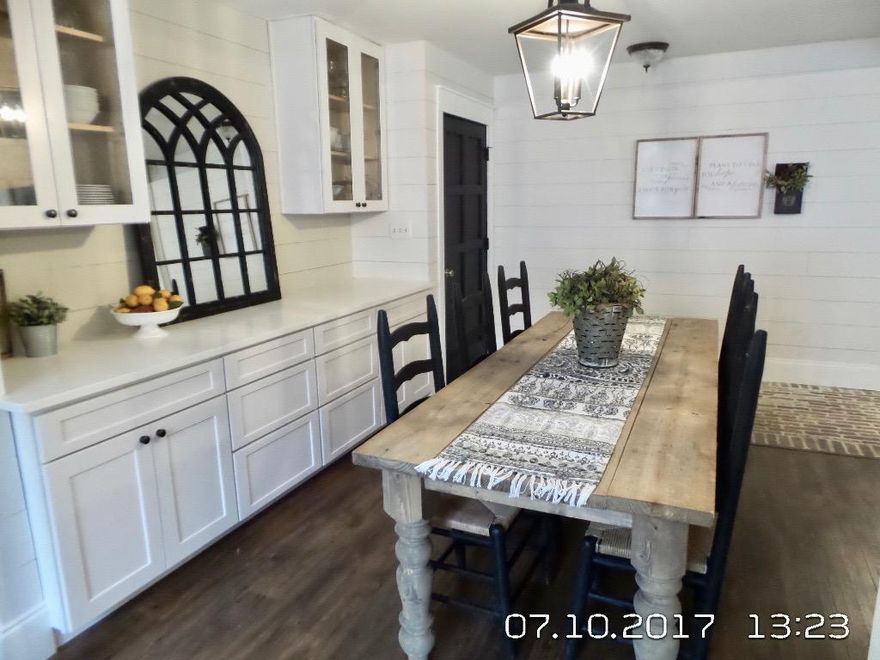 Beautifully designed and upgraded with custom touches...A must see! As you enter the foyer you are greeted with brick flooring that is warm and inviting, and flows naturally into the large living area with a cathedral ceiling and fireplace. Perfect for warming up on cool winter nights. The kitchen has been completely remodeled with new cabinets, appliances, etc. and finished with a unique brick backsplash. Adjacent you find the dining area with extra cabinetry for additional storage and accented with shiplap. The bedrooms are nice sized with custom doors and shiplap accents. Hall bath has been completely upgraded! Outdoors you will find a large screened porch, excellent space for outdoor entertaining. This is a special home with many updates, custom touches, uniquely and tastefully done!