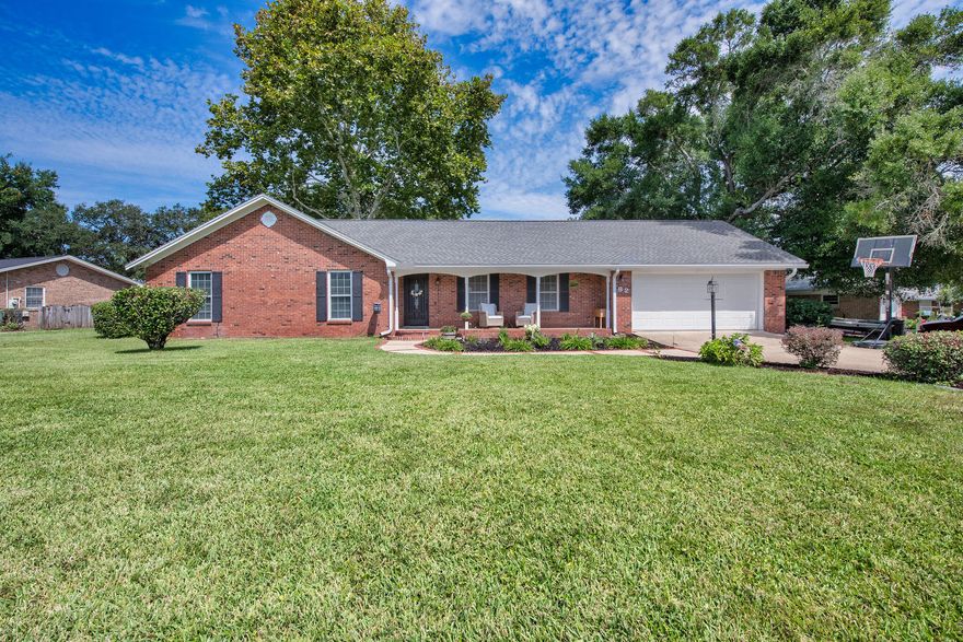 Nestled in the heart of the prestigious Lake Lorraine Estates in Shalimar, this lovely ranch-style home, built in 1978, offers single-level convenience in a sought-after community conveniently close to Eglin AFB, Hurlburt Field, Destin's beaches, and local amenities. With its blend of thoughtful updates, indoor comfort, and outdoor charm, 82 Lake Lorraine Circle is ready to welcome its next owner. The home features a brand-new roof (May 2024), a recently replaced lawn pump (2024), and a 2020 HVAC system. A warm and inviting living area welcomes you with engineered hardwood floors, recessed lighting, and a charming brick wood-burning fireplace. Adjacent is a generous dining space, ideal for family meals or easily divisible for a home office or bonus nook. The open-concept kitchen shines with stainless steel appliances, granite counters, large tile floor, a practical white enamel deep basin sink, and bottom pull out drawer cabinets for ease of use. A large bay-style window fills the space with natural light and offers a picturesque view of the backyard. Off the Kitchen, the spacious laundry room provides abundant counter and cabinet space perfect for pantry overflow or small appliances. Retreat to the primary suite featuring plush high-pile carpeting, a tiled tub/shower combo, and a convenient step-in closet. Each bedroom is also carpeted, enhancing the cozy, tranquil vibe. Outside, the south-facing lot gives way to a true gardener's paradise. The backyard is framed by mature trees that bring bright morning sun and calming afternoon shade. The expansive open patio sets the stage for relaxed outdoor living, while a large, enclosed garden bed, raised garden bed, and a shed offer abundant space for cultivating plants or hobbies. The exterior landscaping bursts with azaleas, gardenias, and hydrangeas, perfectly complementing the covered front porch supported by classic columns and an extended driveway with ample parking. Don't wait to schedule your private showing today! 