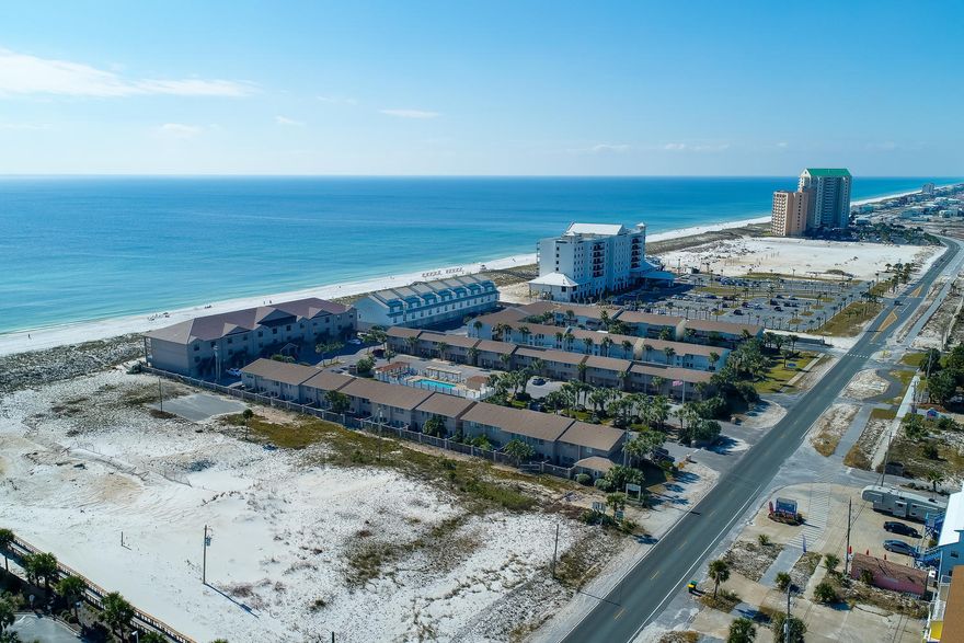 Meticulously maintained 2 bedroom 2 1/2 bath townhouse in a gulf front community. This fully furnished end unit town home features extra windows on side for more natural light, newly installed carpet upstairs, extra large patio with two palm trees, new shed, two outside warm water showers, and two gates. Kitchen includes solid wood cabinets, extra large walk in pantry, and everything needed for cooking. Wake up every morning to views of the Gulf Of Mexico from the master bedroom. Master bedroom has over sized walk in closet and on suite. Enjoy the newly updated heated pool area right across from this townhouse. Pool was updated this year with new paver patio, new gazebo, and pergola. Complex also has a newly installed private beach walk over. Buyers financing fell thru-now is your chance.