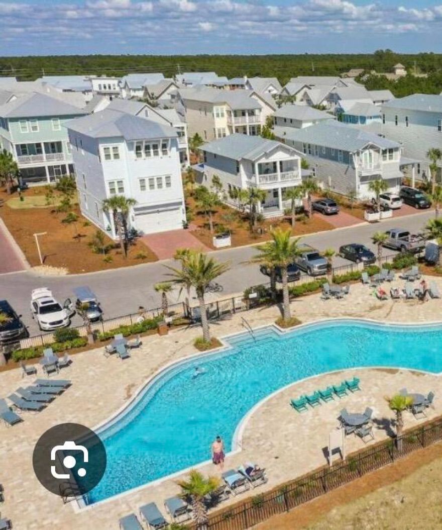 Welcome to your dream retreat in the heart of Prominence, South of scenic 30A! This meticulously designed residence boasts an incredibly desirable floor plan, highlighted by not one, but two luxurious primary bedroom suites, offering unparalleled comfort and flexibility. Perfect for multi-generational living, hosting guests, or creating your own private sanctuaries.Location is everything, and this gem delivers! Situated directly across from the stunning Coastal Resort Pool, you'll enjoy effortless access to refreshing dips and sun-drenched relaxation. Imagine stepping out your door and into a vacation-like atmosphere every day! Located within walking distance of the popular ''Big Chill'' Venue with shopping, multiple restaurants and scheduled entertainment events. Perfect Location!