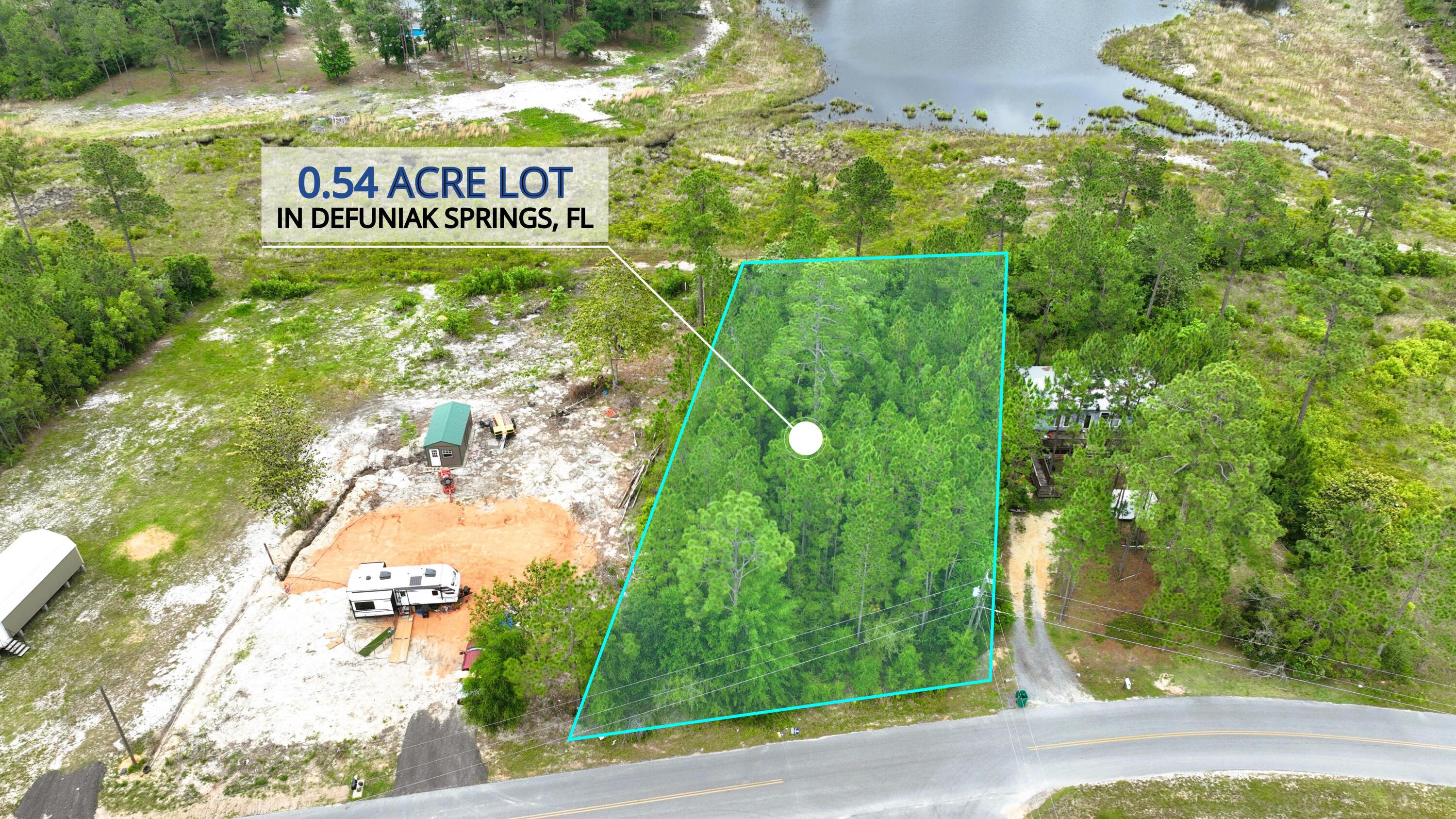 Back on Market!!! Mobile Homes allowed. No HOA. Looking for a waterfront lot? Here is a beautifully wooded with large oaks is located On Lake Rosemary in DeFuniak Springs. City water available. Tap Fee Due. Power available at the road and property would require septic tank. This property is largely flood zone X. This is a fantastic homesite on the water with paved road frontage. Not far from Walton High School and approx.. 10 minutes from town. DeFuniak Springs is approx. 40 minutes to the beautiful beaches of the Florida's Emerald Gulf Coast. Lots of natural resources available from state parks, local area lakes and natural springs, and much more.
