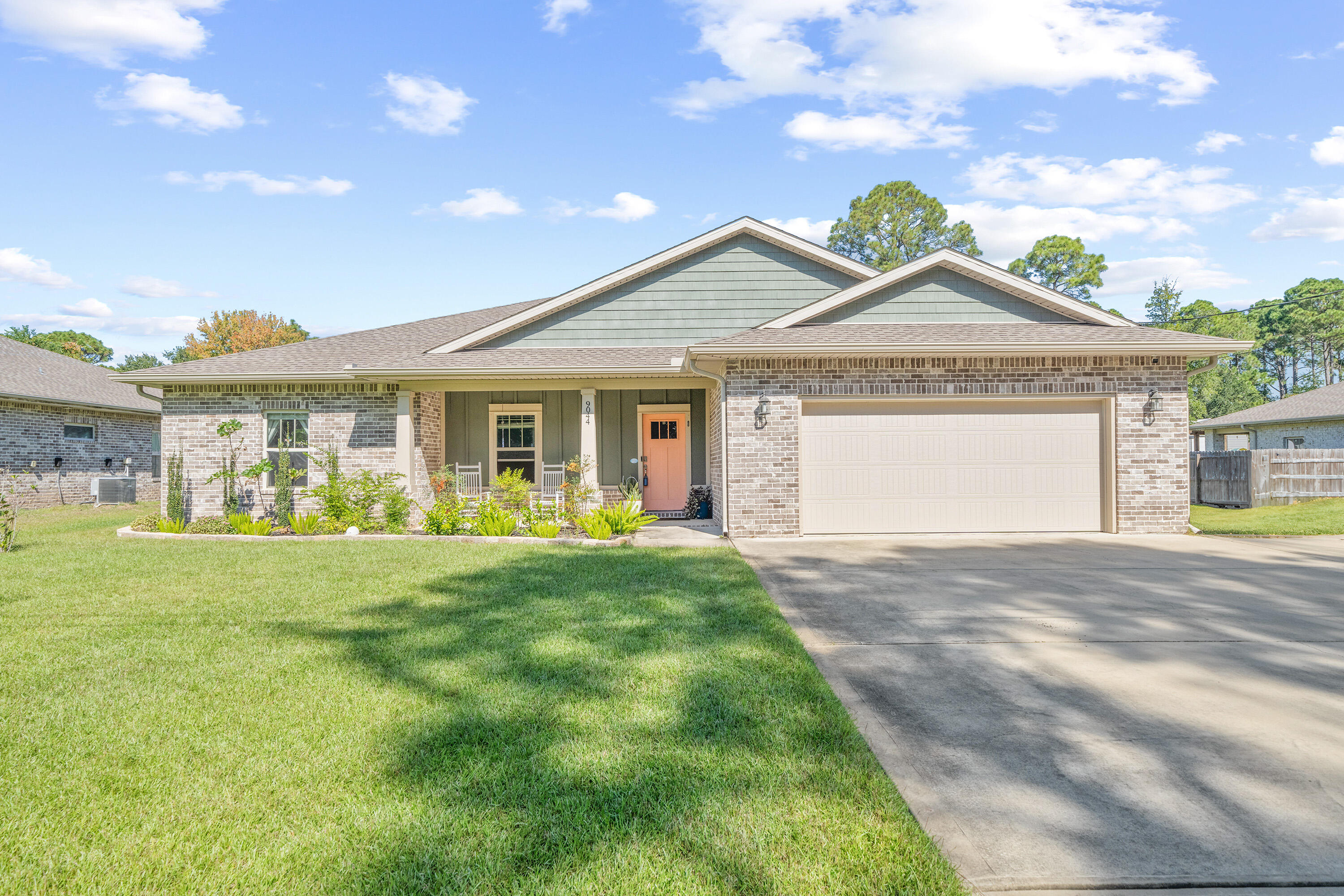 Seller will pay some buyers fees! Exceptional Ramsey Walker built home located in a prime east Navarre location on a half acre lot with many upgrades throughout. Clad in durable cement fiber board with an architectural shingled roof. Sprinkler system and fenced backyard! Interior offers thick wood laminate flooring in the common areas, visually pleasing neutral tile in the baths and laundry room, and carpet in the bedrooms. Custom paint color is accented with a wide baseboard, beautiful crown molding, and spectacular tray ceiling accents in the master bedroom, dining and entry area. Transom windows over the hall entryways provide a high end custom touch. Stainless steel appliances including refrigerator, stunning shaker style cabinets, and granite throughout finish the home exquisitely. Recent upgrades include a new HVAC indoor & outside, Seamless Gutters, fenced Garden area, Chicken coupe, backyard walkway, & mounted TV outlets just to name a few! Cameras & Vivint doorbell stays. Ecobee thermostat. Irrigation system in yard area. Lots of fruit trees including Pear, Fig, Lemon, and Pomegranate. Large lot with over 1/2 acre. Lot goes beyond fence as .56 acres. Extended driveway for extra parking. No flood insurance required & no HOA! Assumable VA loan at 2.25% 