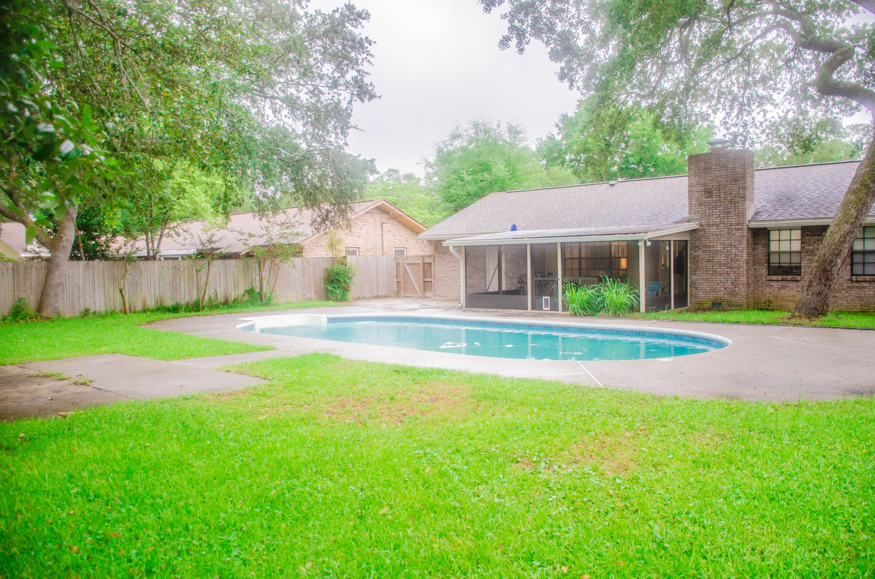 Vacation this summer in and around your beautiful swimming pool! This charming, brick home is centrally located in Niceville making it a short commute to businesses, schools and work. Home has been remodeled to include these notable features: Lovely, lead glass front door,laminate flooring in all common areas with TRAVERTINE tile in bathrooms and frieze carpeting in bedrooms.GRANITE COUNTER TOPS compliment the lovely cabinets. REFRIGERATOR,WASHER AND DRYER CONVEY.Cozy woodburning FIREPLACE is a nice addition for the cool winter evenings and a SCREENED-IN PORCH is a great place for entertaining.Irrigation system has been recently added.If basketball is something you enjoy, you'll love shooting hoops in your spacious fenced-in backyard.This is a great house and will make a wonderful home!