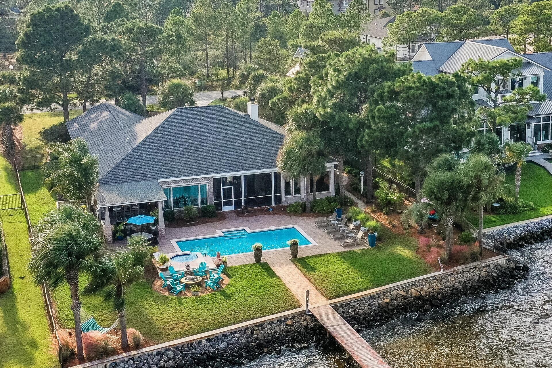 BAYFRONT RESORT W/Stunning Views! Updates Completed in 2021. Hardwood Floors Throughout Main Living Areas,Tile in all Baths, New Carpet in BRs, New Cabinets, Quartz Tops, w/Stainless, 48' Wolf 5-burner cooktop, DBL ovens, SubZero Fridge, Wine Fridge, Wolf MicroW, new sliders everywhere!  Inside & out designed for capturing the Gorgeous BayFront...Open Design, 1 Level plan w/10' ceilings, Plantation Shutters. Living Room w/floor to ceiling built in bookcases w/wiring; Sound System w/Cont. Power Source, Cozy FP, open to Dining Room, excellent flow! Large MSTR w/2 walk-in closets & extended sitting/office area w/wall-wall windows, 2nd MSTR captures stellar bayviews also! Outdoor living is an understatement! To see is to FALL IN LOVE! Pool, Lanai, Comm. grill, generator & every bell & whistle!