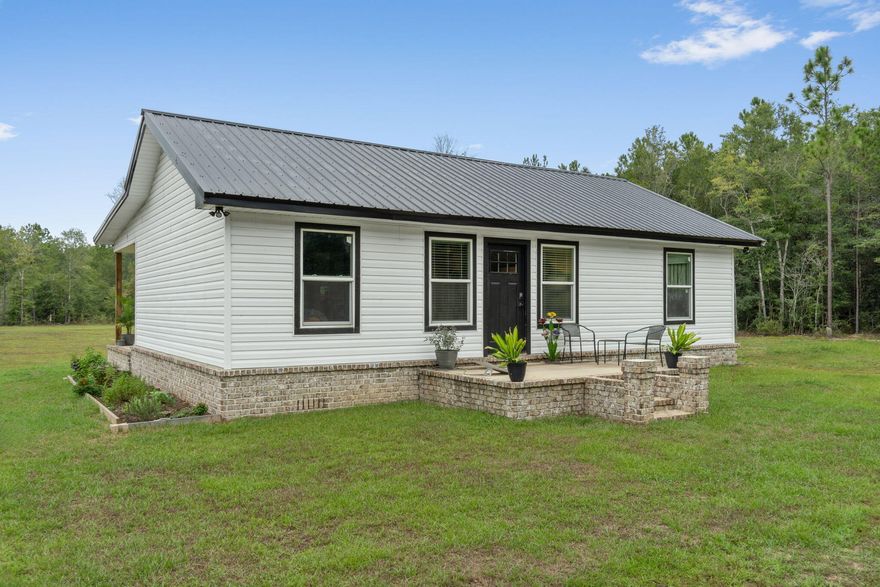 The inside of this 2 year old home features modern amenities and first rate appliances like beautiful new granite countertops in the kitchen and bathroom. Spacious closets, and a large master bedroom, along with a fully insulated shed that comes with a beautiful porch, and includes an upstairs ready for dry wall and AC! This land features almost 10 beautiful untouched acres ready for you to make your mark! Fruit trees such as avocado, peach, lemon and banana as well as beds of herbs and bulbs already planted. There is a fully operational and chicken coop plumbed for easy water access. Multiple hookups throughout the property and a cement slab ready to become a shed, an RV or boat platform, or anything you desire! Other great features include being only a 2 min drive from Black Water!