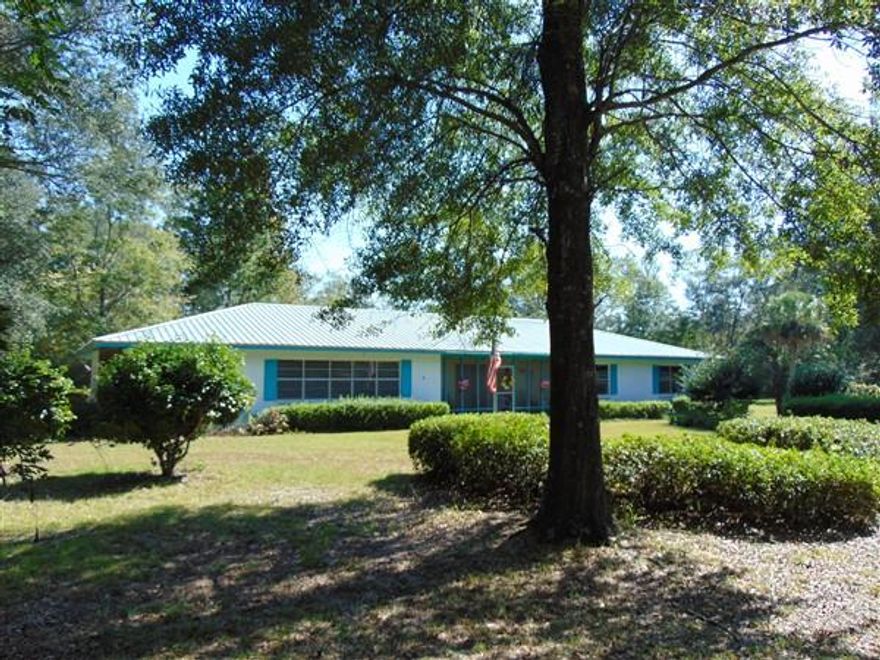 Great buy on this beautiful 12 ac parcel (+/-) with 2400 SF home & detached 3-car carport/shop. This property is located just 2.5 mi from I-10, less than 1 mi to Ponce de Leon Spgs State Park, w/in 45 min to Panama City Beach & the Beaches of S Walton. This solid home was occupied by the original owner from construction in 1970 & still occupied by an original family member. Home is concrete block w/ traditional rafters, so no load-bearing walls making it easy to open up to your liking. 31x15 kitchen & living room with fireplace. FP has 3 blowers & heats the home nicely in the winter. 15x18 family room; formal dining. There is an addtl septic & water meter at the NW corner if new owner would like to build or add a MH. All bedrooms are generous in size. Furniture & other items are negotiable