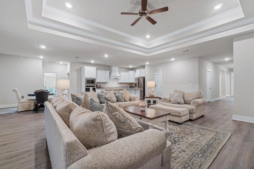 Welcome Home to your truly gorgeous, 5 BEDROOM / 3 FULL BATH split floor plan home. BETTER than waiting for NEW ~ less than 2 months old .Owners sudden relocation is your dream situation to jump in on this ready to move in home. Gorgeous LVP flooring through main living areas ~ Upgraded kitchen with shaker cabinets, granite countertops and chimney extractor hood, home was also FULLY FENCED last week & Professional Blinds installed ~all waiting for you to move in and enjoy ..Situated in the sought after Forest Bay Estates with no through traffic /a winding newly established neighborhood with sidewalks and large community gazebo and POOL. This home offers 3118 sq. ft. of true family living space with a great floor plan for the larger family or guests. Welcomed by pleasing curb appeal....  Craftsman Style front porch enhanced by beach feel colors and long covered front porch ~exquisite inside and out.
.On entering this impressive home, you will be greeted by the grand foyer with wood look LVP flooring, large office/flex room, welcoming dining room with trey ceiling, crown molding and large enough to accommodate the family dining table. Extended hallway to your huge Great room ... light and bright with 10 ft. trey ceiling, down lights and ceiling fan all enjoying an open flow to the breakfast nook and Gorgeous Kitchen with shaker cabinets, granite countertops, vented cooktop and in wall oven & microwave~ dream walk in huge pantry, S/S appliances, Center Island and breakfast bar overlooking the nook & great room. Master bedroom is split from the other bedrooms and has a trey ceiling with fan and door to the undercover porch. Master bath~ granite double sink vanity, garden soaking tub, separate step in shower, private WC and huge walk-in closet. All additional bedrooms are a great size with good size closets. Two bedrooms at the side of the home have a Y-shape hallway with additional closet storage and share a full bathroom with granite vanity, shower/tub. The 4 & 5th bedrooms would also make a great guest area being separate from the other bedrooms and provides another full bathroom, shower/tub, granite vanity, linen closet. Home enjoys a large covered porch  ~great to grill out and enjoy those wonderful Florida evenings.... Garage with panel access for attic storage, and door remotes. Home is also fitted with fabric shield storm protection shutters. Call today to arrange your tour of this wonderful family home.
