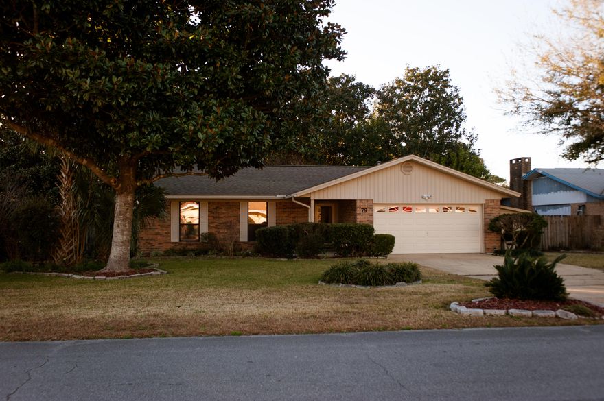 This immaculate home with beautifully landscaped lawn is an ideal home or retreat. Central to Eglin Air Force Base and Hurlburt Field, it's near many nature sites as well as the beach. A fully renovated kitchen equipped with side by side refrigerator, stainless steel range with hood over an elongated, granite top island, custom cabinets and soft close drawers is upscale and will please any cook. Your new home is freshly painted in neutral tones, has ceramic tile throughout that meets hardwood laminate flooring in the living room; carpeting only in the bedrooms. A brick fireplace with ventilation generates more warmth through out the living room. Home Warranty gives peace of mind. French doors open up to a serene backyard with a patio and fountain surrounded by lush vegetation; welcome Home