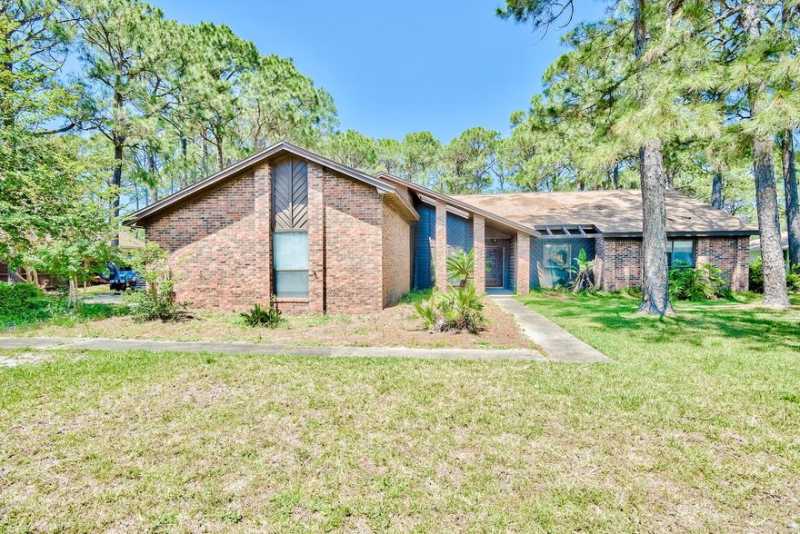 This home features a large living and family space with a beautiful double sided fireplace. It is located on the 9th tee box of Indian Bayou Golf Club and offers a very spacious lot. With a screened in porch overlooking the salt water pool and golf course, you can't beat the location and views!
