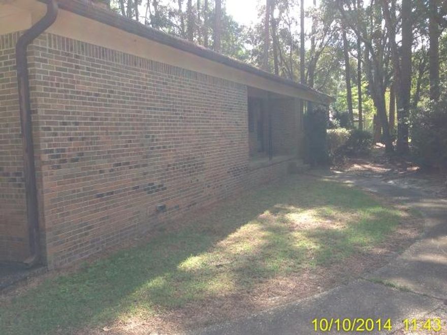 Privately situated on nearly an acre of land, this Quaint Brick house is surrounded by several mature trees creating the privacy a country setting would offer. Featuring a beautiful stone faced gas fireplace in the living room, a fully screened back porch, 2 car garage, 3 bedrooms and 2 full bathrooms! Don't miss out on this opportunity to own your own rustic retreat with in the city limits!