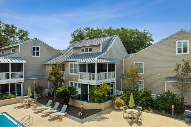 ATTENTION INVESTORS! 50k PRICE REDUCED...& RENTAL PROJECTIONS OF OVER 50K! Best Priced Listing In All Of Hidden Dunes. This charming three-bedroom, two-bathroom beach house on the second floor provides a picturesque view of the resort's main swimming pool. The large living area features high ceilings and connects seamlessly to a screened porch. Furnished with a spacious flat-screen TV, DVD player, and new furnishings, the living room offers comfort and entertainment. The updated kitchen boasts stainless steel appliances, a granite countertop with bar stools for casual dining. The master bedroom on the first floor includes an attached bathroom and a king-sized bed, with a private screened porch overlooking the pool. The first guest bedroom features a queen-sized bed, while another another guest bathroom is conveniently located on the main floor. A spiral staircase leads up to a loft where a second guest bedroom with two twin beds awaits. For additional guests, a sleeper sofa is available in the living room. Hidden Dunes Beach & Tennis Resort provides a range of amenities such as a serene lake with a fishing pier, a horseshoe pit, a basketball court, top-notch tennis facilities, and outdoor grills for barbecues.