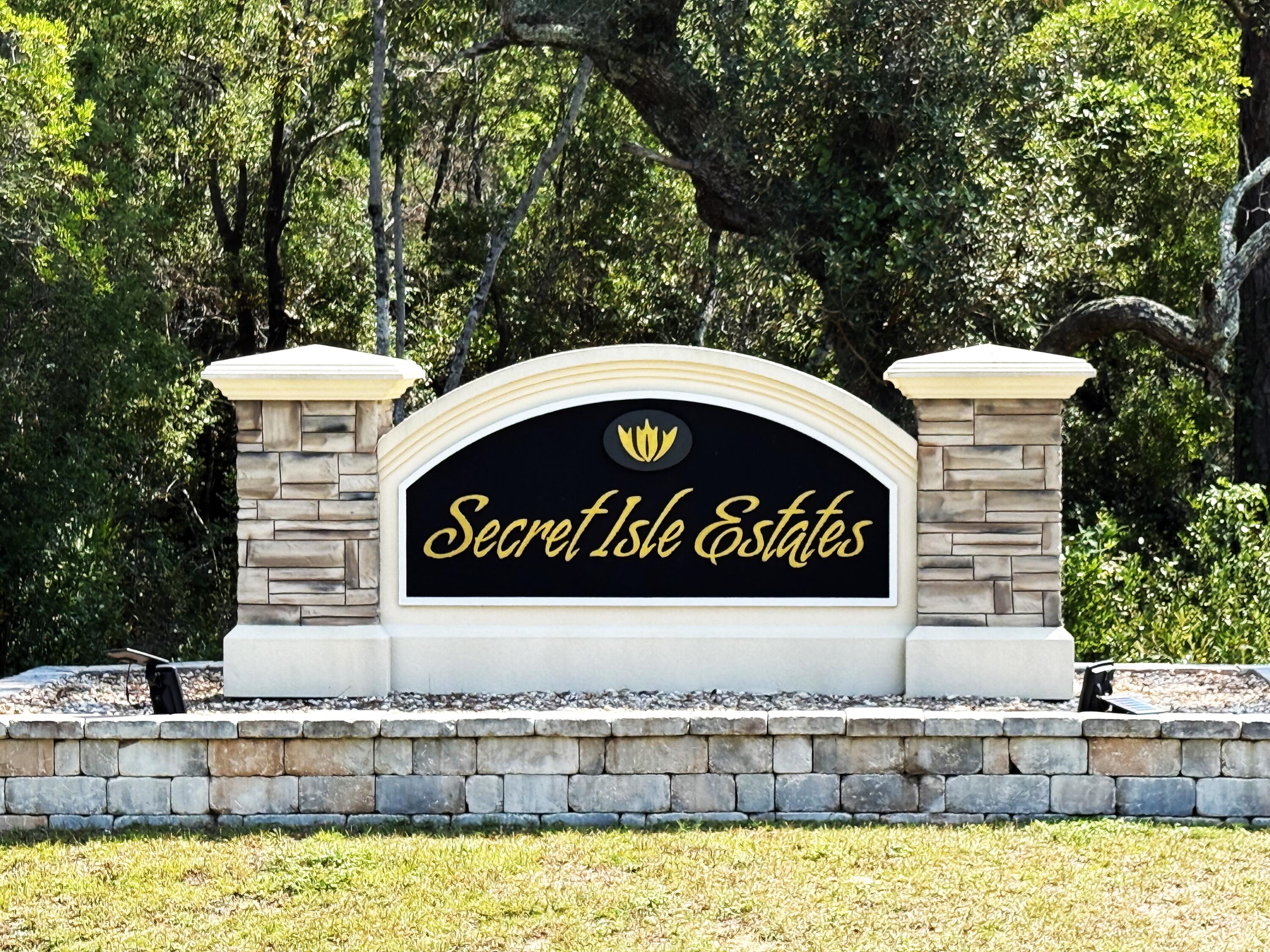 Welcome to the most secluded neighborhood in Navarre, SECRET ISLE ESTATES, surrounded by a natural preserve. This one-of-a-kind development by HERBST HOME BUILDERS is only minutes from shopping, restaurants, A+ Schools, and the sugary white beaches. The newly, beautiful 5 BR/3 BA brick home sits on one of the largest lots with a 6 ft. Privacy Fence. The open floor plan with a spacious living room, dining room, and kitchen area is great for entertaining. This home has a separate En Suite BR and all luxury extras you can imaging, grey Luxury Vinyl Floors throughout, White Shaker Cabinets w/ Under Cabinet Lighting, Stainless Steel Appliances, Ivory White Granite, 5' Baseboards, Crown Moldings in main areas, Towering Ceiling Trays in living room and master suite, Custom Blinds on all windows