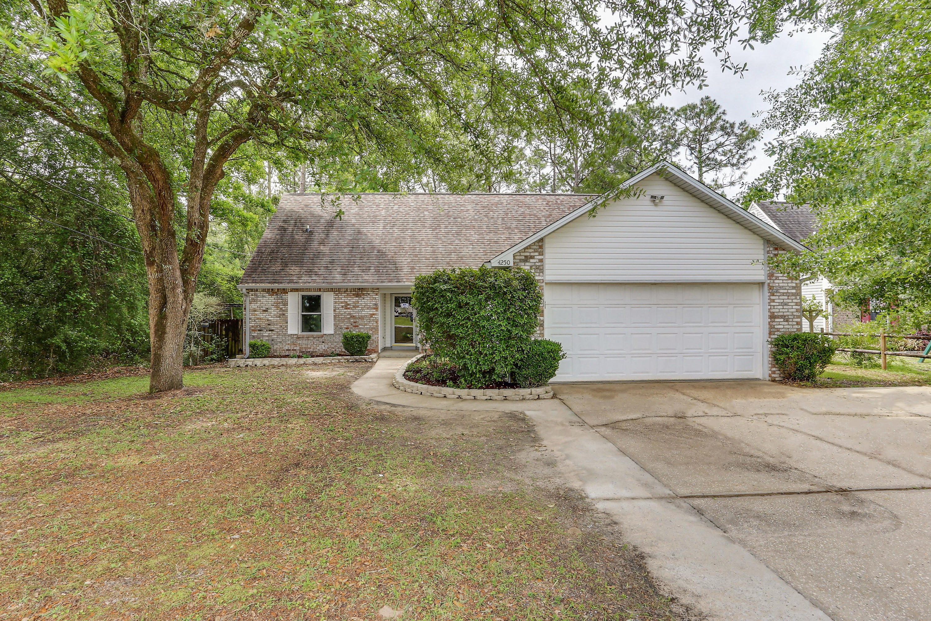 MOVE IN READY!!! This amazing 5 bedroom, 3 bath home offers a fully renovated beautiful kitchen with custom cabinets, soft close drawers and granite counter tops, brand new carpet, wall to wall interior paint, newer roof (6 yrs) , upgraded storm windows , tankless water heater, transferable termite bond and mother in law suite!! Perfectly located on a level lot which backs up to a heavily wooded area , great for added privacy in south Crestview - EASY SHORT, COMMUTE TO BASE!