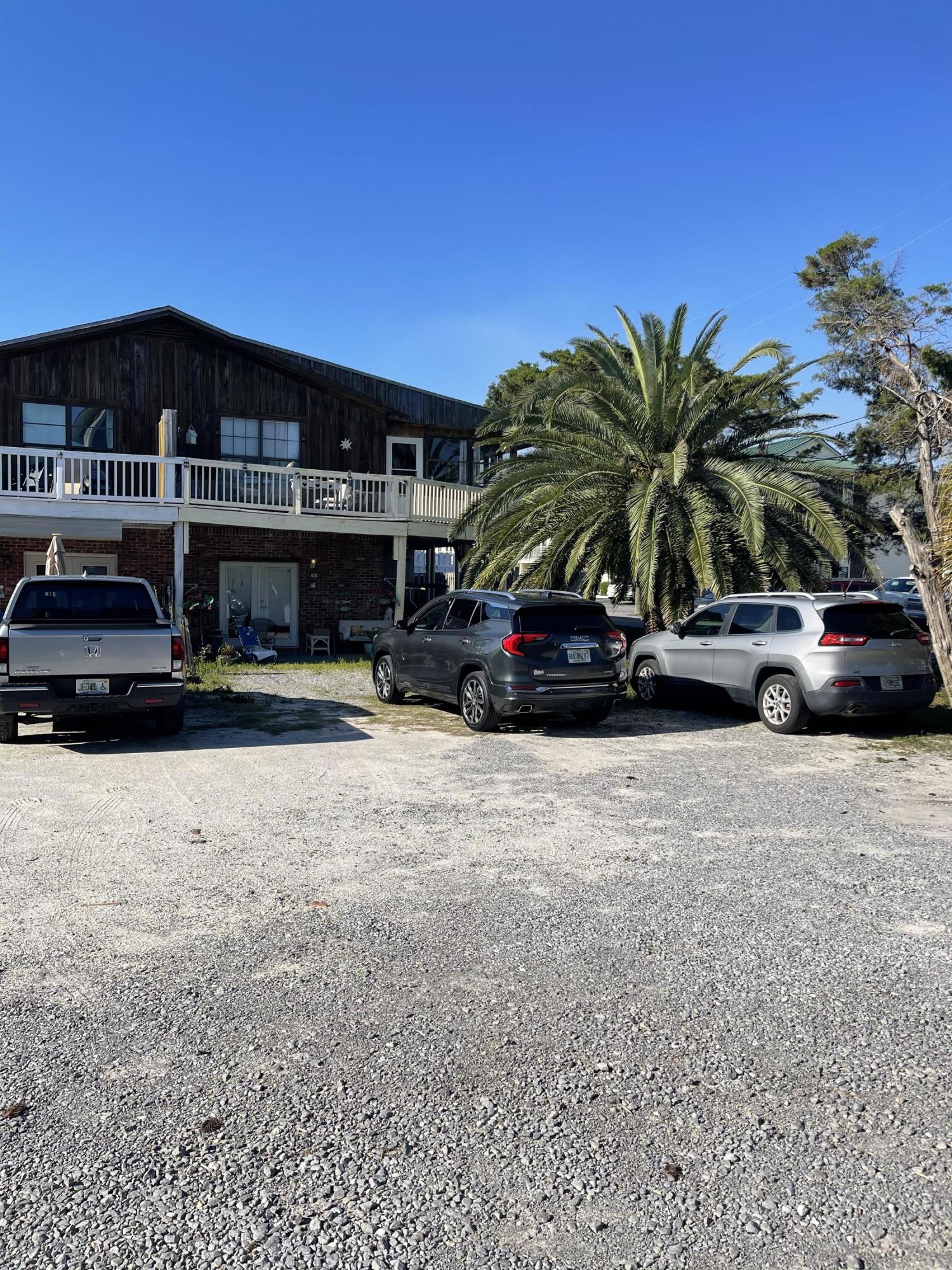 INVESTORS! 2100 ft from the beach! LOCATION LOCATION! This is a unique income property! It is one half of a quadplex with 2 separate apartments! Upstairs is 2 bedrooms, 2 bath with a huge screen porch & deck. You can see the gulf from the upper deck! Downstairs is a 1 bedroom apartment with patio area and storage. This can mirror the upstairs and a bedroom may be added for it to be two bedrooms. Each half of the quadplex, with 2 units, is separately deeded. Currently the upper unit is owner occupied & the downstairs is a long term rental. Even as a long term rental this place is a gem. Walking distance to the beach makes it a PERFECT vacation rental as well! There is unbelievable potential in these two units! This building is just a short walk to the beach near Pompano Joes.