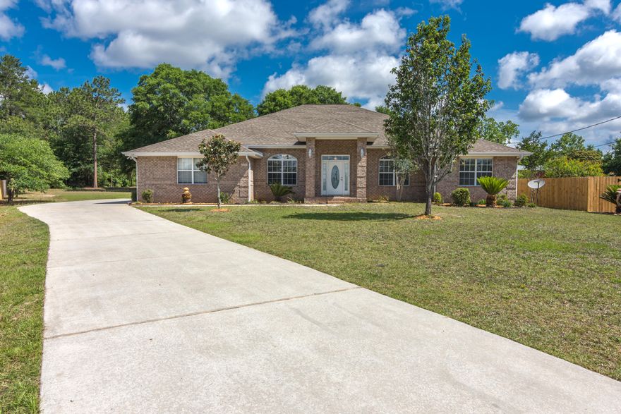 Move-In-Ready 4 bed 3 bath home sitting on .71 acre lot located in north Crestview. Home has recently been freshly painted as well as new carpet installed through out. Large living room is great for entertaining friends and family and is open to the kitchen providing additional seating at the bar. Kitchen boasts ample counter and cabinet space for all your cooking needs. Large master bedroom suite and master bath with separate tub and shower as well dual vanity. Large bedroom with its own bathroom in the hall which is great for a mother in-law-suite or guest area with its own access to the back porch from the bathroom. Flex room as well formal dining room at the main entry.