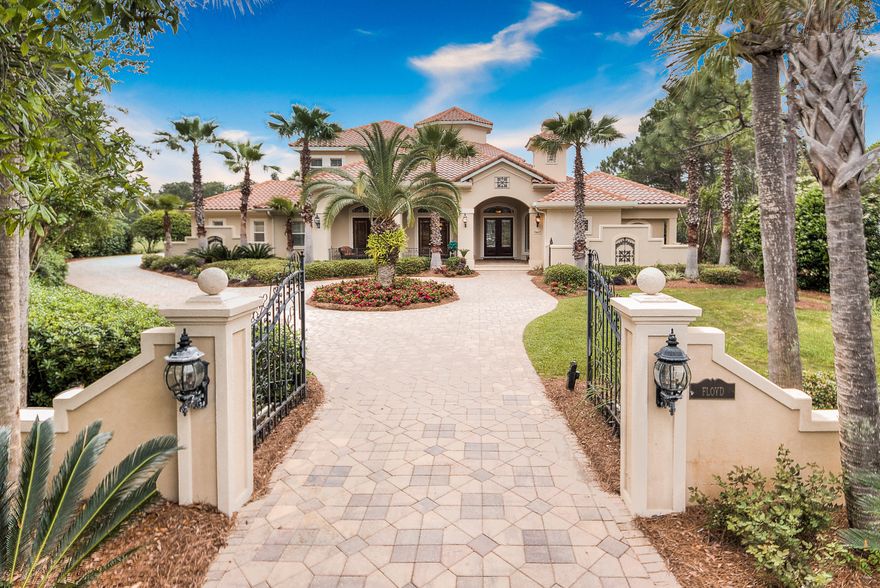 Tuscan charm greets you as you pass the magnificent iron gate. Enter through leaded glass and mahogany double doors to experience the breathtaking view of the outdoor living space and golf course beyond, the view framed by the impressive floor to ceiling curved glass wall of the living room. Like any proper Tuscan villa, the heart of the home is the sumptuous kitchen where the old world charm of rich cabinetry and intriguing stone surfaces merges with today's finest gourmet appliances, which include a 6 burner Thermador gas stove and 3 dishwashers. Tile flooring runs throughout the main living areas, allowing one room to flow seamlessly into the next. A butler's pantry & wet bar facilitate either formal dining or casual entertaining. Disappearing sliders on 2 sides of the family room draw the pool and outdoor kitchen into the fabric of the home. The home boasts two offices - one looking out over the front veranda, the other at the rear overlooking a lake and the golf course. Beautiful custom cabinetry adorns the back office, the family room entertainment wall, and the gathering/media room on the second level. Completing the main level are a wine closet, a huge laundry room, a guest bedroom sharing the large pool bath, and an opulent, private master suite on the opposite side of the main living areas. Upstairs, 2 bedrooms and a huge full bath open into a spacious gathering room with a built in media center and a morning kitchen/wet bar. SOLD FURNISHED INCLUDING THE WALL AND WINDOW TREATMENTS  the numerous chandeliers and ceiling fans, the generous use of moldings and trim, and the tasteful blends of granite and stone give this warm and inviting home a special touch of elegance. CALL TODAY TO SEE THIS GREAT HOME !