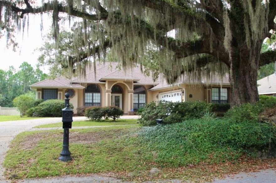 One of the most beautiful and popular locations in SOUTH Crestview--Juniper Creek--is about as far south as you can go and still be in Crestview! Very convenient to bases, shopping, and dining! This lovely contemporary home has a very open floor plan featuring 3 bedrooms and a study that can be used as a bedroom. All tile floors for easy care! Well designed kitchen featuring solid surface countertops and lots of lovely cabinets and includes a pantry. Formal dining room has gorgeous treyed ceiling plus this home has a large breakfast room. Study is right off of the foyer. The large living room has a corner fireplace and triple slider doors that open onto the covered rear porch. Split bedroom design. Huge, oversized garage. Circular driveway! Beautiful leaded glass entry door.