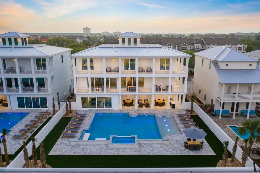 Welcome to ''Hypnautic'', a luxury newly constructed beach house, boasts of 6650 square feet across three levels, featuring multiple indoor areas, outdoor living areas, fourth floor rooftop observation deck with panoramic gulf views. This property is thoughtfully designed to optimize maximum space for up to 30 guests and parking for over 10 vehicles. Walk the short distance to nearby beaches or enjoy the amenities provided in this beach retreat, including a superior outdoor space with resort style heated pool, hot tub, in-pool concrete picnic table, Royal Teak outdoor furniture and full outdoor kitchen. The large sliding doors on the first and second floor lend to that California style living with seamless outdoor-indoor living on two levels. Other notable features are in-home multi level movie theater, home elevator, Sonos system, multiple arcades, pool table and no HOA. Lifelike synthetic turf provides zero maintenance and year-round beautification. This home has it all the essentials for entertaining: rental machine was thoughtfully designed to optimize sleeping capacity without compromising quality and function with almost $400,000 in projected annual income. Sold fully furnished and rental ready for up to 30 guests.