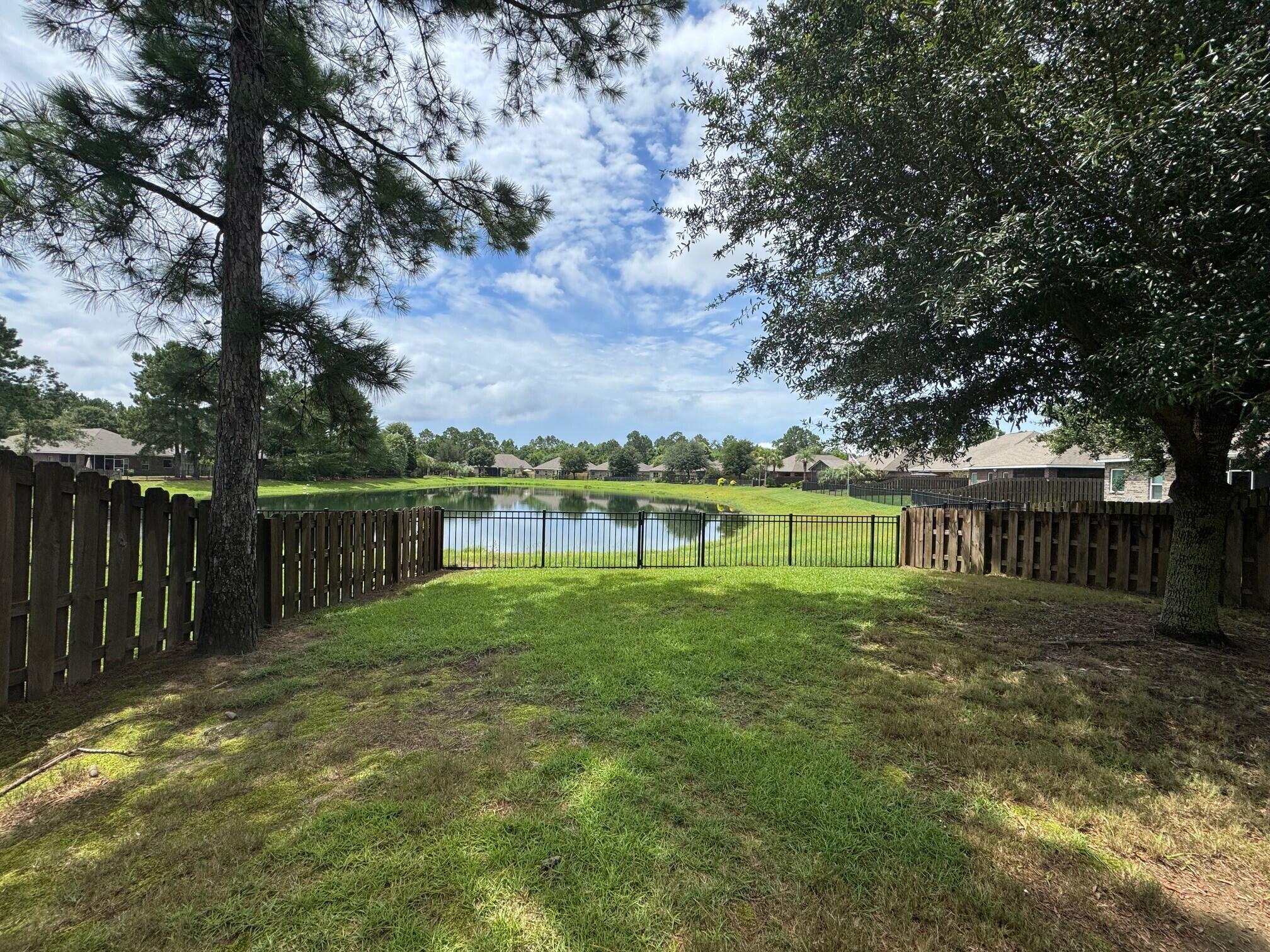 Lake front in Hammock Bay! This home boasts a large great room, ground floor master bedroom, large yard and extra-long driveway for plenty of parking. This well laid out floorplan has 4 bedrooms. The large bedroom upstairs could also be used as a teen/game room: there are plenty of options. The living area is open and bright. Kitchen features granite counter tops, stainless steel appliances, and a large kitchen island. All appliances included in the kitchen. The large primary suite offers views of the lake. Primary bath features large tile shower, split vanities with granite counters. Out back enjoy the patio with views of the lake or walk down to the water and try your luck catching a bass or pan fish. The fenced back yard is perfect for family bbq's and enjoying the great outdoors! The Passages neighborhood in Hammock Bay is a short walk to all amenities including Canine Commons (the dog park), three swimming pools, the hammock bay clubhouse, tennis, basketball, pickle ball courts, the amphitheater, brewery and 60 acre sports complex! Hammock Bay has a full time Event Coordinator for weekly activities, festivals, farmers' markets and entertainment! 125 Whitman also has an individual mailbox for your convenience. Buyer to verify all information impt to them.