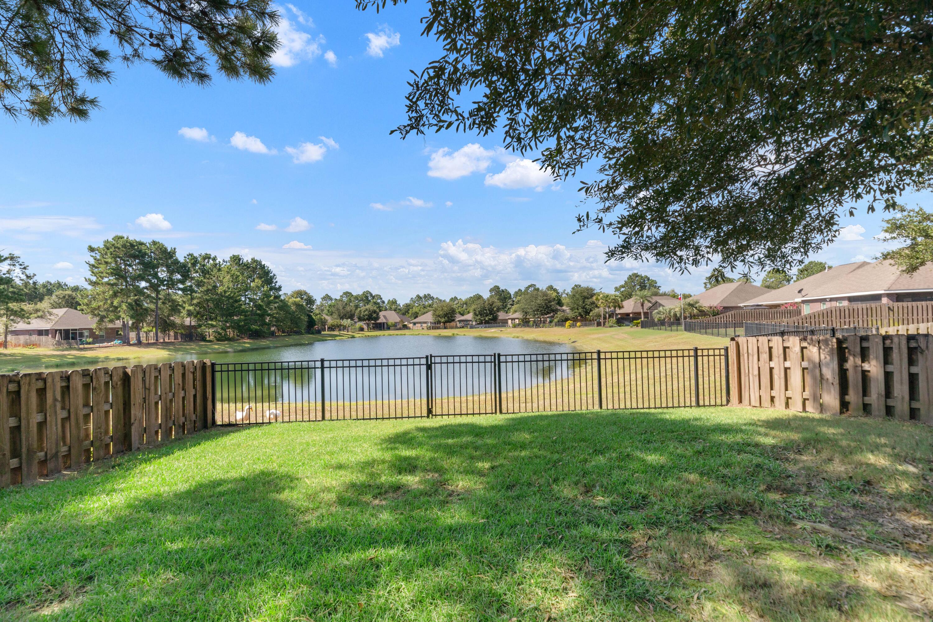 Lake front in Hammock Bay! This home boasts a large great room, ground floor master bedroom, large yard and extra-long driveway for plenty of parking. This well laid out floorplan has 4 bedrooms. The large bedroom upstairs could also be used as a teen/game room: there are plenty of options. The living area is open and bright. Kitchen features granite counter tops, stainless steel appliances, and a large kitchen island. All appliances included in the kitchen. The large primary suite offers views of the lake. Primary bath features large tile shower, split vanities with granite counters. Out back enjoy the patio with views of the lake or walk down to the water and try your luck catching a bass or pan fish. The fenced back yard is perfect for family bbq's and enjoying the great outdoors! The Passages neighborhood in Hammock Bay is a short walk to all amenities including Canine Commons (the dog park), three swimming pools, the hammock bay clubhouse, tennis, basketball, pickle ball courts, the amphitheater, brewery and 60 acre sports complex! Hammock Bay has a full time Event Coordinator for weekly activities, festivals, farmers' markets and entertainment! 125 Whitman also has an individual mailbox for your convenience. Buyer to verify all information impt to them.