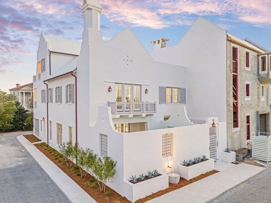 Designed by Byron K. Smith and built by Alys Beach Construction, with interiors by James Design, this thoughtfully furnished corner-lot residence offers an expansive floor plan with 4+ bedrooms plus a bunk room and 6.5 baths, spanning over 5,300+ square feet of heated and cooled space. A 400-square-foot rooftop terrace, accessed through a 5-panel Nano door, provides breathtaking panoramic gulf views. This seamless indoor-outdoor transition creates an ideal layout for entertaining while taking in the beauty of 30A sunsets. Built with fortified concrete construction, the home offers both durability and sophistication, blending timeless architecture with modern luxury. The first-floor exterior features a private entry courtyard with tranquil water features, leading to the Zaguan area, an outdoor oasis complete with an expansive pool, spa, outdoor kitchen, and large fireplace, designed for year-round enjoyment. Inside, White stone pavers flow through the first floor with sandbar-stained oak flooring on the second and third floor, complementing expansive tray ceilings with pecky cypress beams and Venetian plaster walls. The kitchen is a chef's dream, featuring an oversized island, WOLF/Sub-Zero appliances, a Wolf coffee maker, and a separate wet bar with a wine fridge, beverage cooler, and ice machine. A walk-in pantry, laundry room, and custom Ashley Norton door hardware complete this level. The Zaguan back entrance offers custom wood screens, shutters, ample storage, and a drop zone for all your beach essentials. The second floor is designed for privacy and luxury, featuring a grand primary suite with a private study, Venetian plaster ceiling, and an exterior loggia porch. Wake up to serene gulf views from the king-sized bed, while the primary bath boasts a double vanity, custom linen cabinet, steam shower with dual shower heads, and an expansive walk-in closet. The Jr. primary suite features an en-suite bath and private balcony overlooking the loggia and pool. A bunk room includes two sets of full-over-queen bunk beds with its own en-suite bath, while two additional guest suites, each with private baths, provide ample accommodations. A second-floor laundry room adds convenience. The third floor is an entertainer's retreat, boasting an elegant cypress wood ceiling, a wet bar with a beverage cooler and ice machine, and a full bath with a walk-in shower and double vanities. Step onto the covered terrace or the expansive rooftop terrace, where panoramic gulf views set the perfect backdrop for relaxation or entertaining. A two-car garage with the ability to accommodate a double car lift completes this exceptional home. Perfectly situated in the heart of Alys Beach, this extraordinary residence offers a rare opportunity to experience the pinnacle of coastal luxury. Inquire today to learn more.