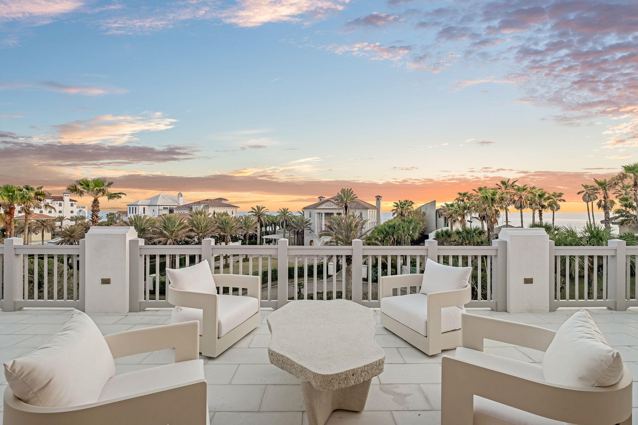 Designed by Byron K. Smith and built by Alys Beach Construction, with interiors by James Design, this thoughtfully furnished corner-lot residence offers an expansive floor plan with 4+ bedrooms plus a bunk room and 6.5 baths, spanning over 5,300+ square feet of heated and cooled space. A 400-square-foot rooftop terrace, accessed through a 5-panel Nano door, provides breathtaking panoramic gulf views. This seamless indoor-outdoor transition creates an ideal layout for entertaining while taking in the beauty of 30A sunsets. Built with fortified concrete construction, the home offers both durability and sophistication, blending timeless architecture with modern luxury. The first-floor exterior features a private entry courtyard with tranquil water features, leading to the Zaguan area, an outdoor oasis complete with an expansive pool, spa, outdoor kitchen, and large fireplace, designed for year-round enjoyment. Inside, White stone pavers flow through the first floor with sandbar-stained oak flooring on the second and third floor, complementing expansive tray ceilings with pecky cypress beams and Venetian plaster walls. The kitchen is a chef's dream, featuring an oversized island, WOLF/Sub-Zero appliances, a Wolf coffee maker, and a separate wet bar with a wine fridge, beverage cooler, and ice machine. A walk-in pantry, laundry room, and custom Ashley Norton door hardware complete this level. The Zaguan back entrance offers custom wood screens, shutters, ample storage, and a drop zone for all your beach essentials. The second floor is designed for privacy and luxury, featuring a grand primary suite with a private study, Venetian plaster ceiling, and an exterior loggia porch. Wake up to serene gulf views from the king-sized bed, while the primary bath boasts a double vanity, custom linen cabinet, steam shower with dual shower heads, and an expansive walk-in closet. The Jr. primary suite features an en-suite bath and private balcony overlooking the loggia and pool. A bunk room includes two sets of full-over-queen bunk beds with its own en-suite bath, while two additional guest suites, each with private baths, provide ample accommodations. A second-floor laundry room adds convenience. The third floor is an entertainer's retreat, boasting an elegant cypress wood ceiling, a wet bar with a beverage cooler and ice machine, and a full bath with a walk-in shower and double vanities. Step onto the covered terrace or the expansive rooftop terrace, where panoramic gulf views set the perfect backdrop for relaxation or entertaining. A two-car garage with the ability to accommodate a double car lift completes this exceptional home. Perfectly situated in the heart of Alys Beach, this extraordinary residence offers a rare opportunity to experience the pinnacle of coastal luxury. Inquire today to learn more.
