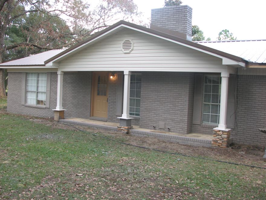 This home is located on a private easement with large mature trees on a .96 acre lot in a quite setting. The exterior of the home is being remodeled at this time, with a new metal roof, new paint, 2 car carport, new covered back porch, and landscaping. The interior is getting additional square footage added to master suite with a walk in closet, and laminate wood flooring. In the tiled living area you will find a wood burning fireplace. The nice open kitchen has breakfast bar and pantry. Bathrooms, lighting, kitchen, and textured wall and ceiling were updated in 2009. HVAC and water heater were replaced in 2007. This all brick home has a lot to offer any prospective buyer.