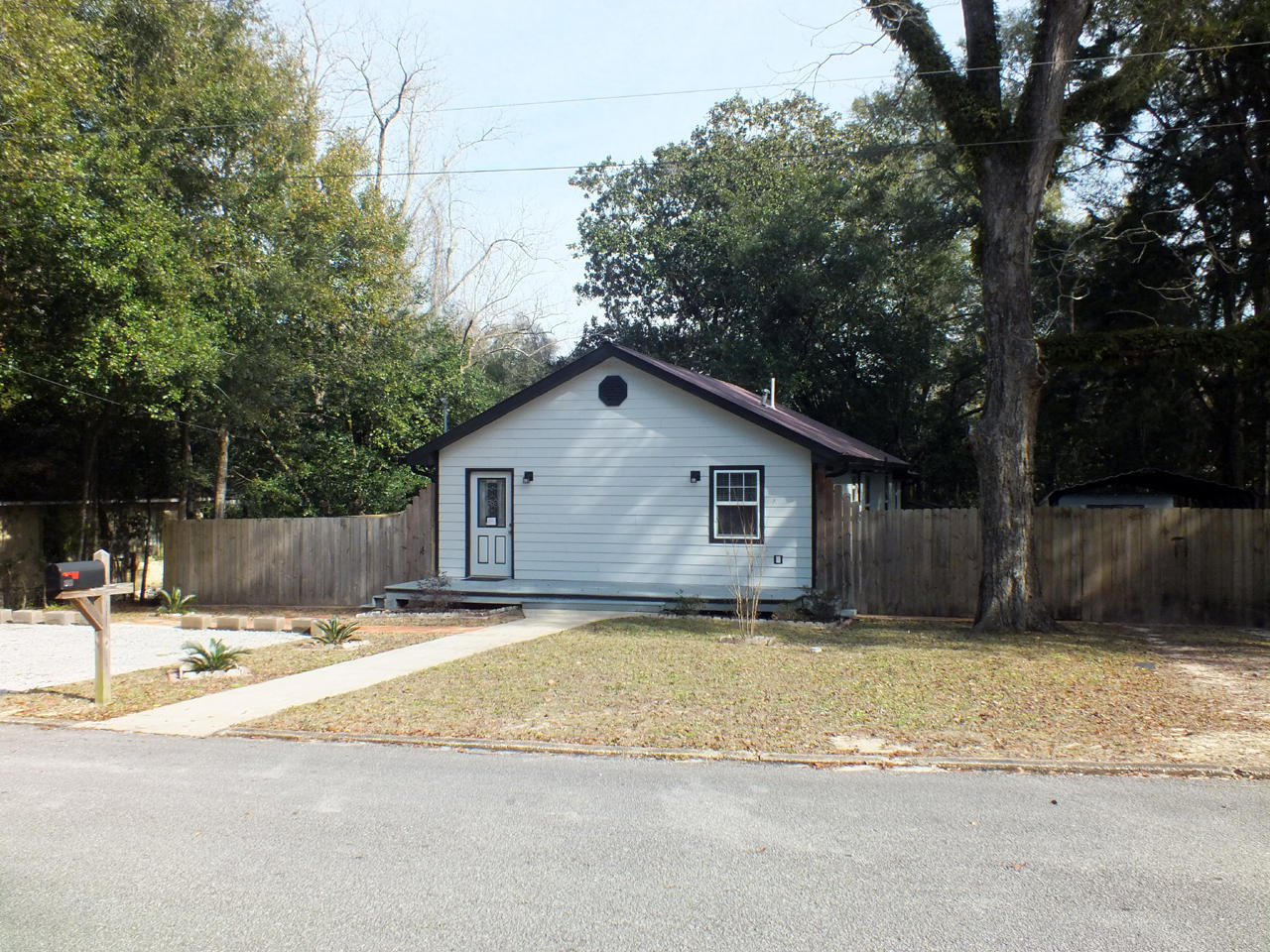 The house, originally built around 1900, has been completely upgraded by the previous and current owners. The interior features oak floors in the living room and dining areas, plush carpet in the bedrooms and ceramic tile in the kitchen and bathroom. The kitchen has solid wood cabinets, solid counter tops and stainless steel appliances. The bathroom has been recently updated. The house could be considered energy efficient due to updated windows and insulation in the walls, ceiling and under the floors. The exterior has hardy plank siding and a metal roof with gutters. The front porch is 6x24, the side porch is 12x24 and the back porch is 4x8. A 6 ft fence completely surrounds the house and carport for added privacy. The house is a 10 minute walk to historic downtown DeFuniak Springs.