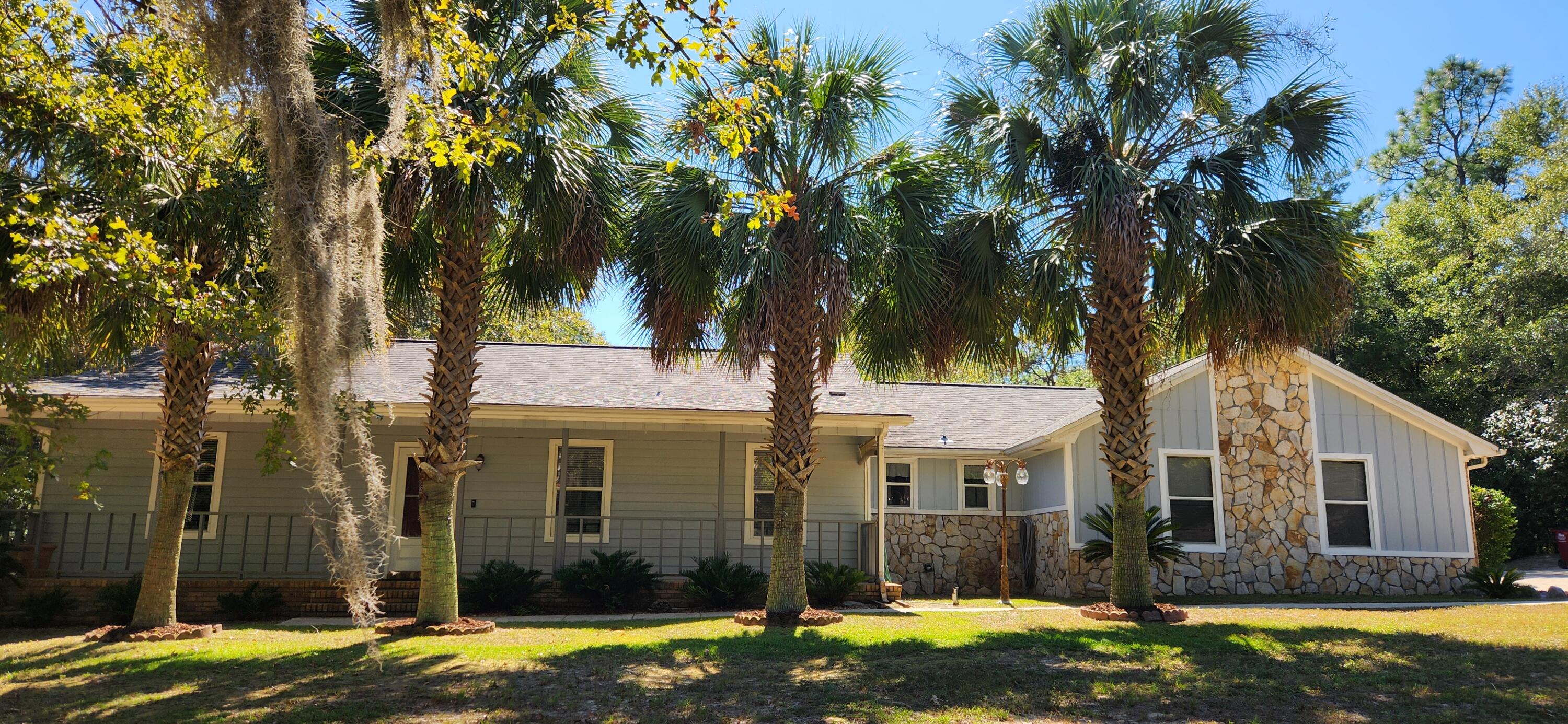 Beautiful home in a wonderful peaceful neighborhood. Picturesque curb appeal with beautiful Palm trees and moss in the mature oaks trees. Sitting on 1 acre of land there is large fenced back yard made for entertaining. Enormous 20x20 covered patio awaiting all of your grilling out adventures with family or friends. Back yard adorned with beautiful water oaks that you will just have to see. And there is out building for storage or a workshop. Entering the front of the home you will find a large covered porch waiting for your rocking chairs and watching the hummingbirds. Inside you will be greeted  with a very large family room with beautiful vaulted ceilings with wood beams and a wood burning fireplace for the upcoming cozy winter nights. Nice kitchen with a large dining area. All appliances convey including a wonderful refrigerator. Off the kitchen is the large laundry room with plenty of storage and a mud sink. Washer and Dryer go with the home! Oversized garage with plenty of cabinets and work space and a unique closet in the garage perfect for a safe room or extra storage. Master bedroom is large in size and master bath has a double vanity, walk in tiled shower and a large walk in Closet. The other two bedrooms are very ample in size as well as another full bathroom. Seller will give piece of mind with a 1 year home warranty and the home has a current termite bond that can be transferred to owner. So much to list, you'll just have to come out and view it yourself! Don't miss out on this wonderful home!