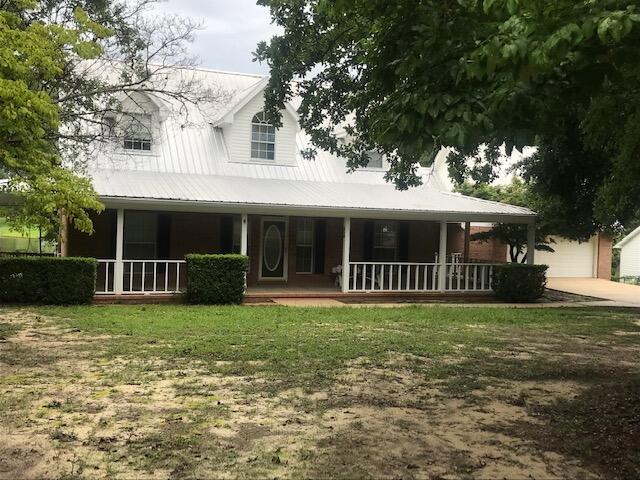 If Location is the Key - This has it! Located outside the city limits, yet within 5 minutes to shopping, schools, churches, businesses, and on one of the largest Lakes in the area! Over 123 Feet on a 20+- acre spring fed, well stocked lake! Home is so nice and Cozy - the wrap-around porch will take you back to days gone by - sit in the swing, front or back and enjoy the pleasant breezes. Entertainment possibilities galore - From large covered back porch to inground pool and deck - or on the large Front Veranda. Mature Oak trees provide shade and esthetics. Home is well designed with Master Bedroom and large Bath with Whirlpool tub and separate shower downstairs, upstairs 2 large bedrooms with ample storage space - Great rooom ceiling extends to the second story and has a real