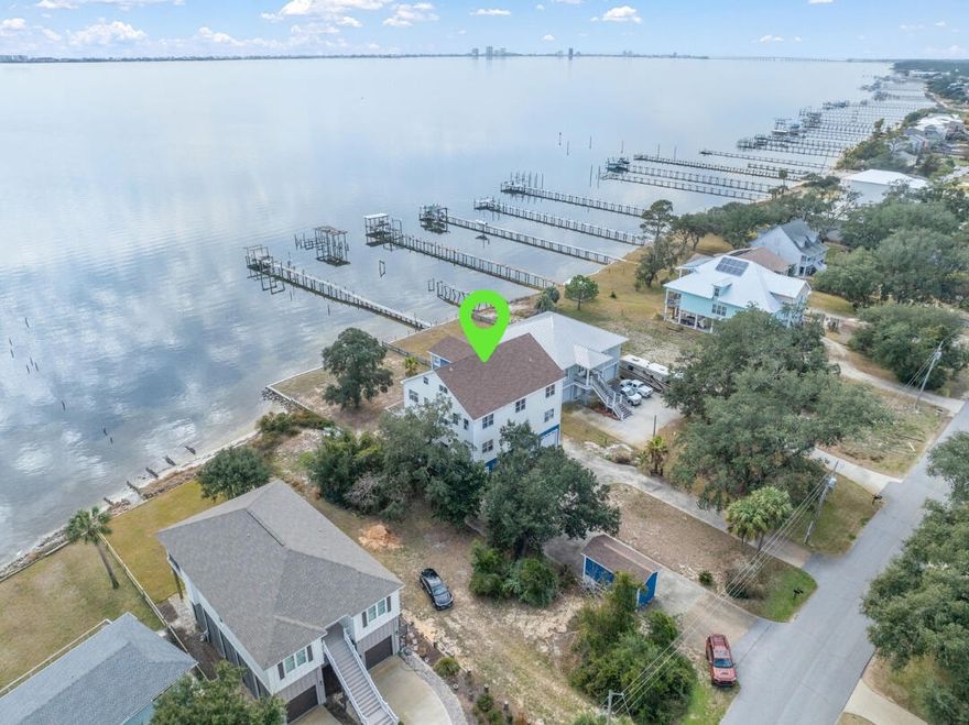 Welcome to your waterfront dream home on the picturesque Santa Rosa Sound in Gulf Breeze, FL! This 4-story property offers expansive water views from each floor and is grandfathered in to allow a full 4th floor of living space, making it a one-of-a-kind gem in this waterfront community. Constructed of hardie plank siding on 2x6 framing on concrete slab and 12'' pilings. Located less than a quarter of a mile from the Oriole Beach Boat Ramp, this property provides unbeatable access to boating and water activities. The structure is already equipped with a 3 stop elevator shaft - All that's needed is the installation, and we have detailed quotes ready for you! The ground floor is equipped with a 2 car garage and a separate apartment with its own climate controlled 1-car garage bay, offering privacy for guests, family, or rental opportunities. The 2nd floor houses the main living space. Featuring the kitchen with a large granite breakfast bar & stainless steel appliances, dining area, and the living space - all with an incredible view of the sound, 2 large bedrooms with a Jack&Jill bathroom, and a half bath. Up the stairs to the 3rd floor, you'll find the primary suite - complete with a private balcony with THE MOST AMAZING VIEW, 2 walk-in closets, oversized ensuite with 2 separate sinks, garden tub, and separate shower. Off the primary suite, is an office space/bonus room. Across the hall is another large bedroom with ensuite and another bedroom at the end of the stairs. The 4th floor massive flex room is ready for you to make your own and includes an already plumbed and wired bathroom space. Each floor is equipped with its own HVAC system to keep everyone comfortable. It's ready to become the space of your dreams! Make this amazing space your waterfront paradise!
